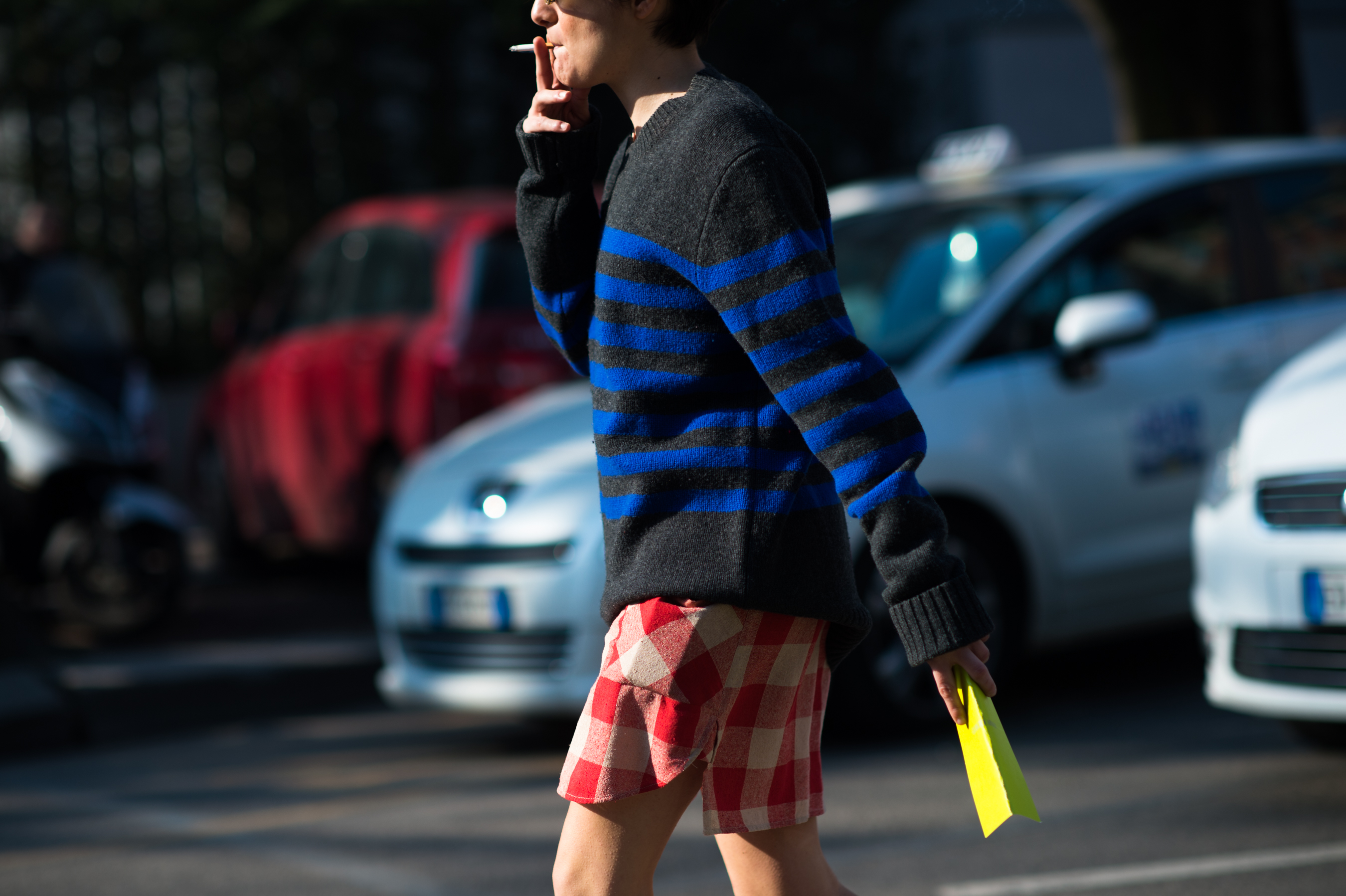 Woman wearing a plaid skirt and striped top