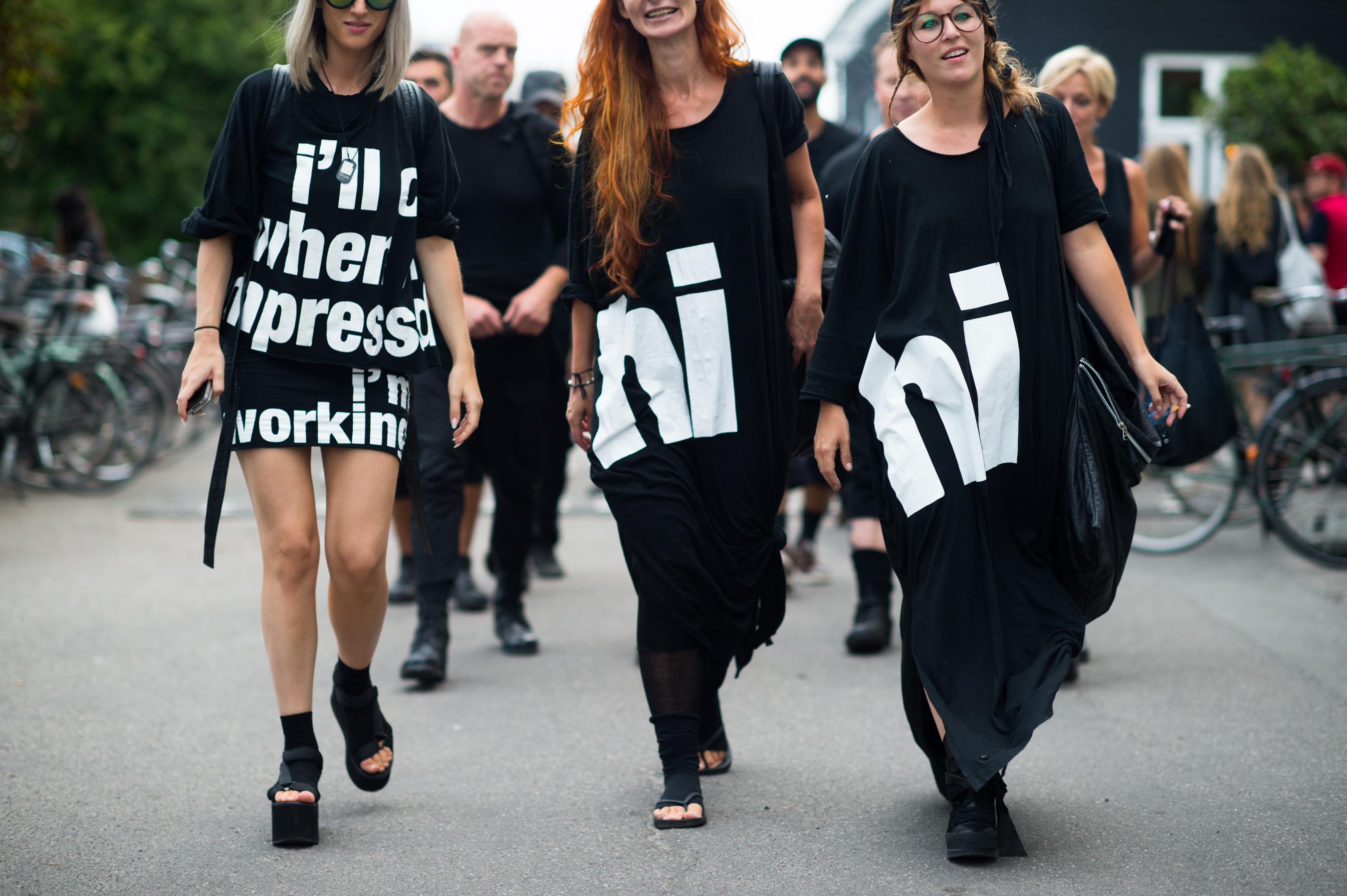 Three women wearing graphic T Shirts