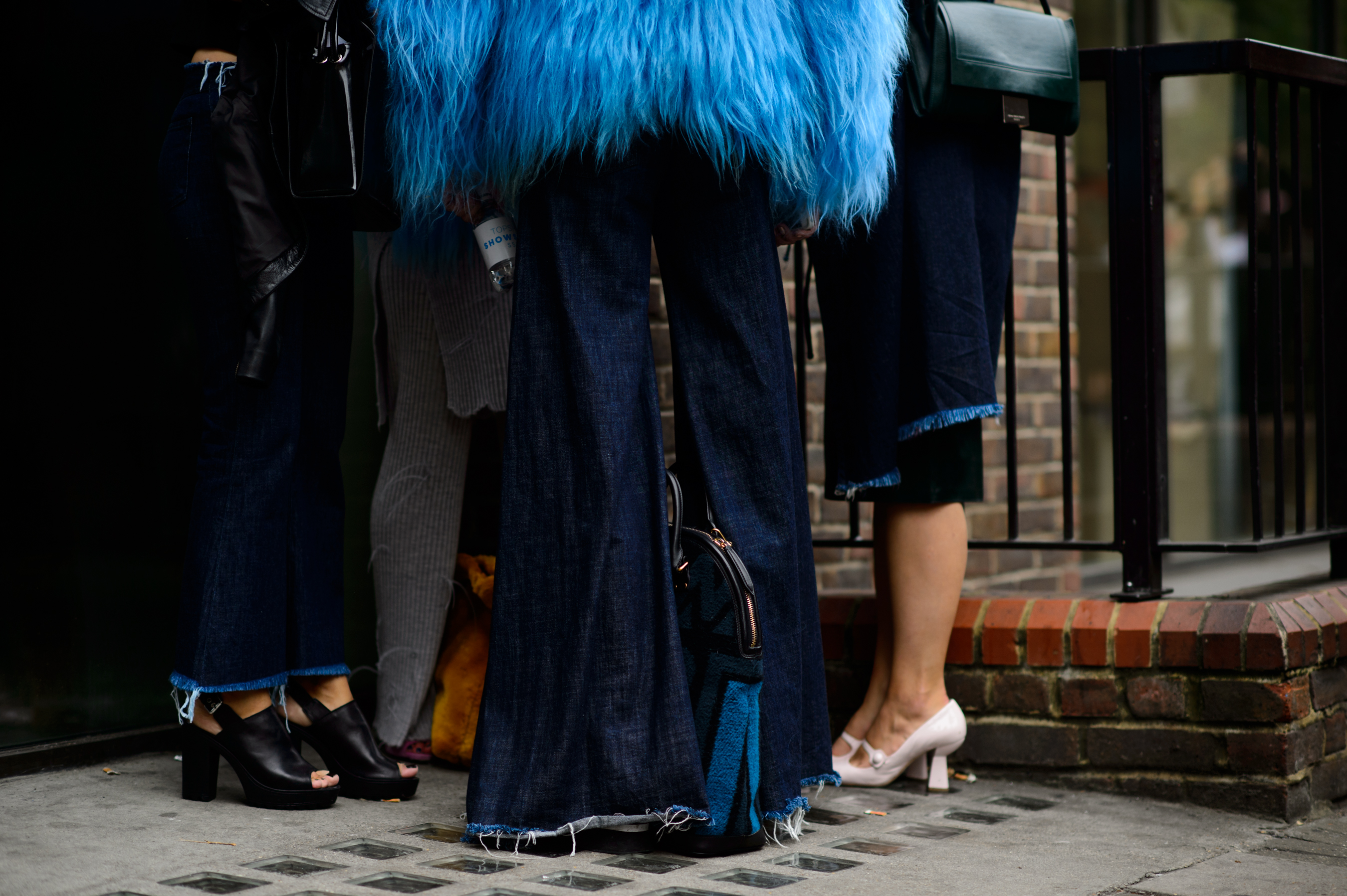 Three women wearing destroyed denim