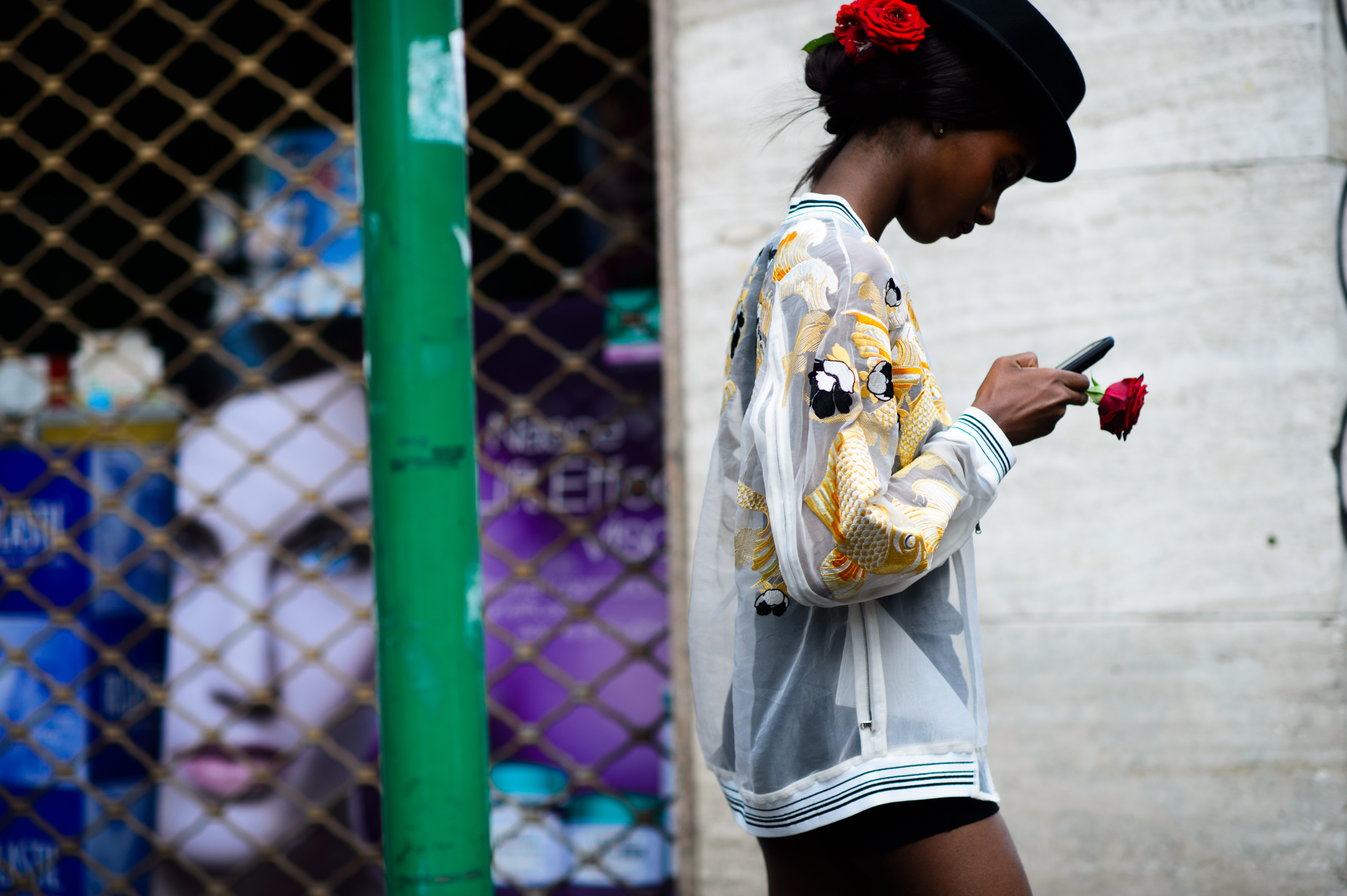 Model texting with roses in her hair