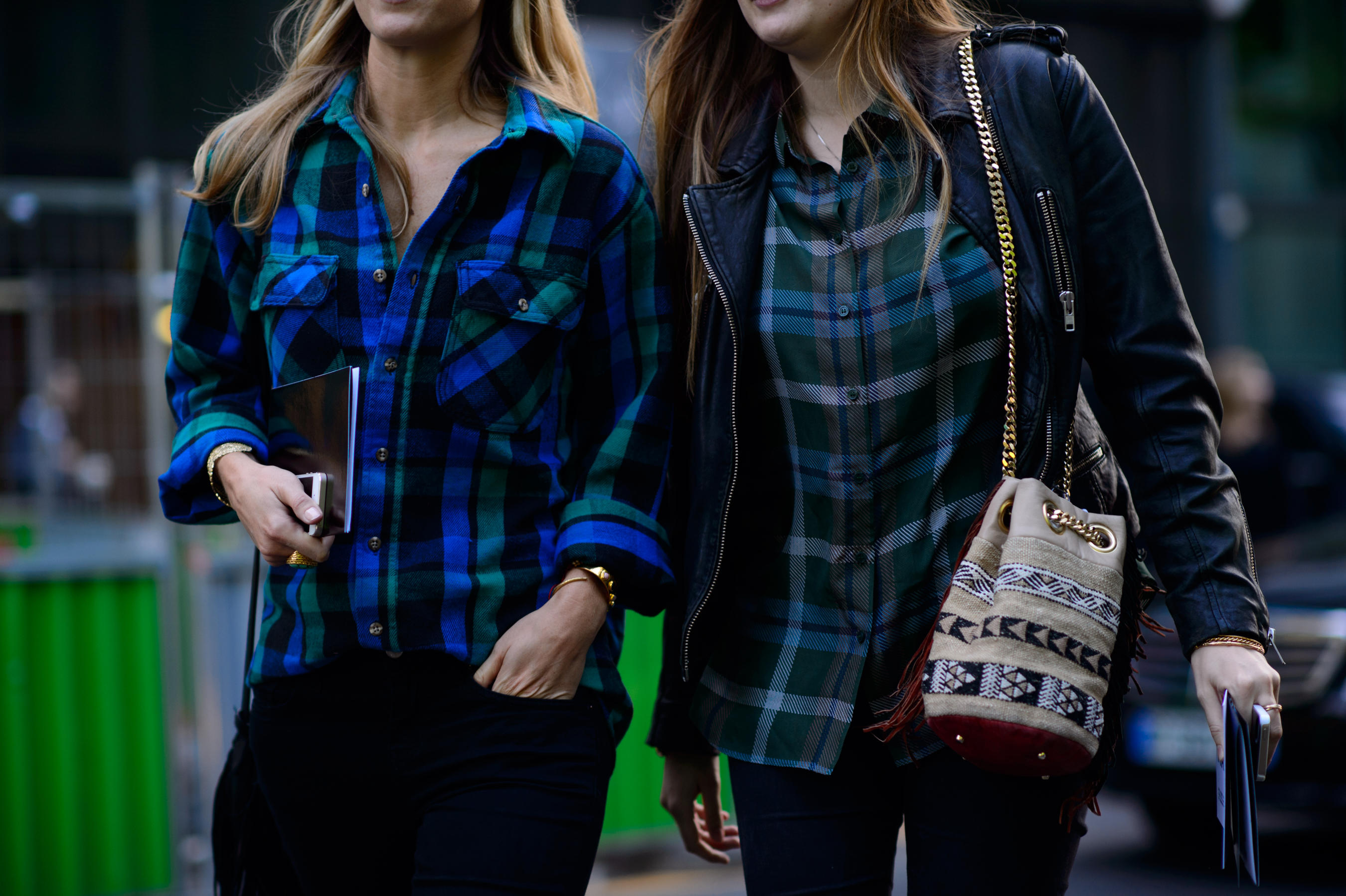 Two women wearing plaid shirts