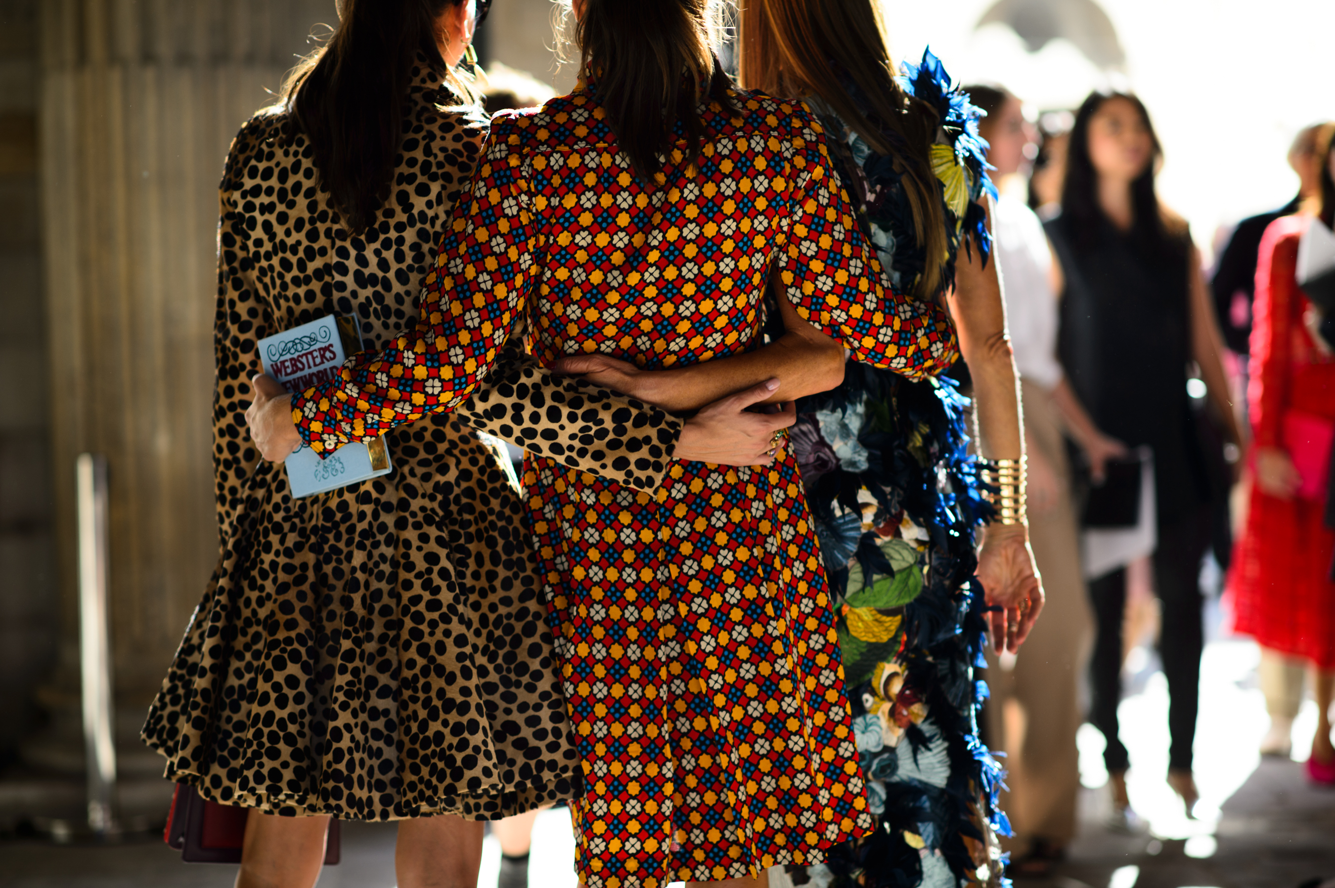 Three Italian women holding each other