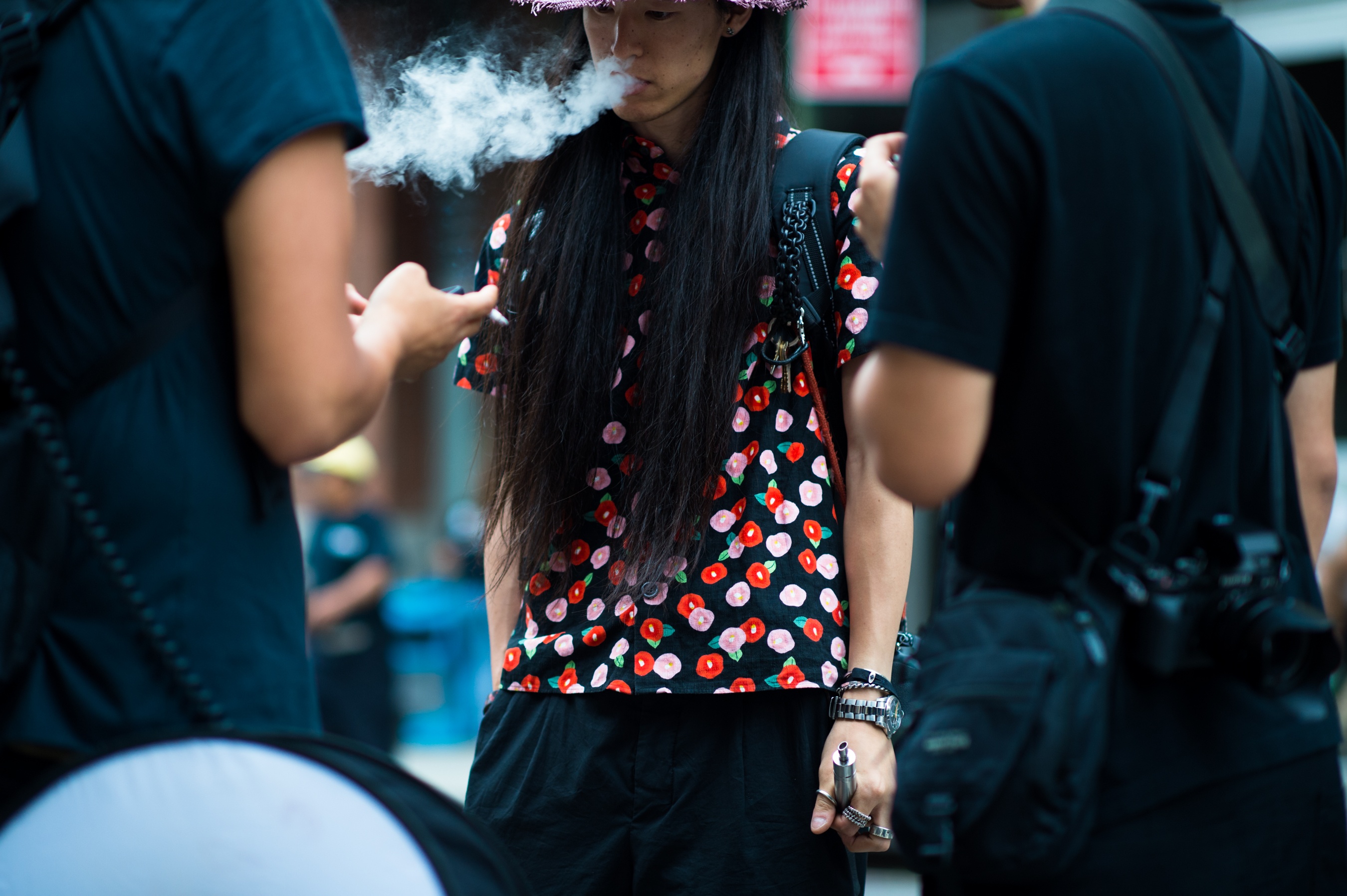 Japanese photographer smoking a vaporizer in Raf Simons