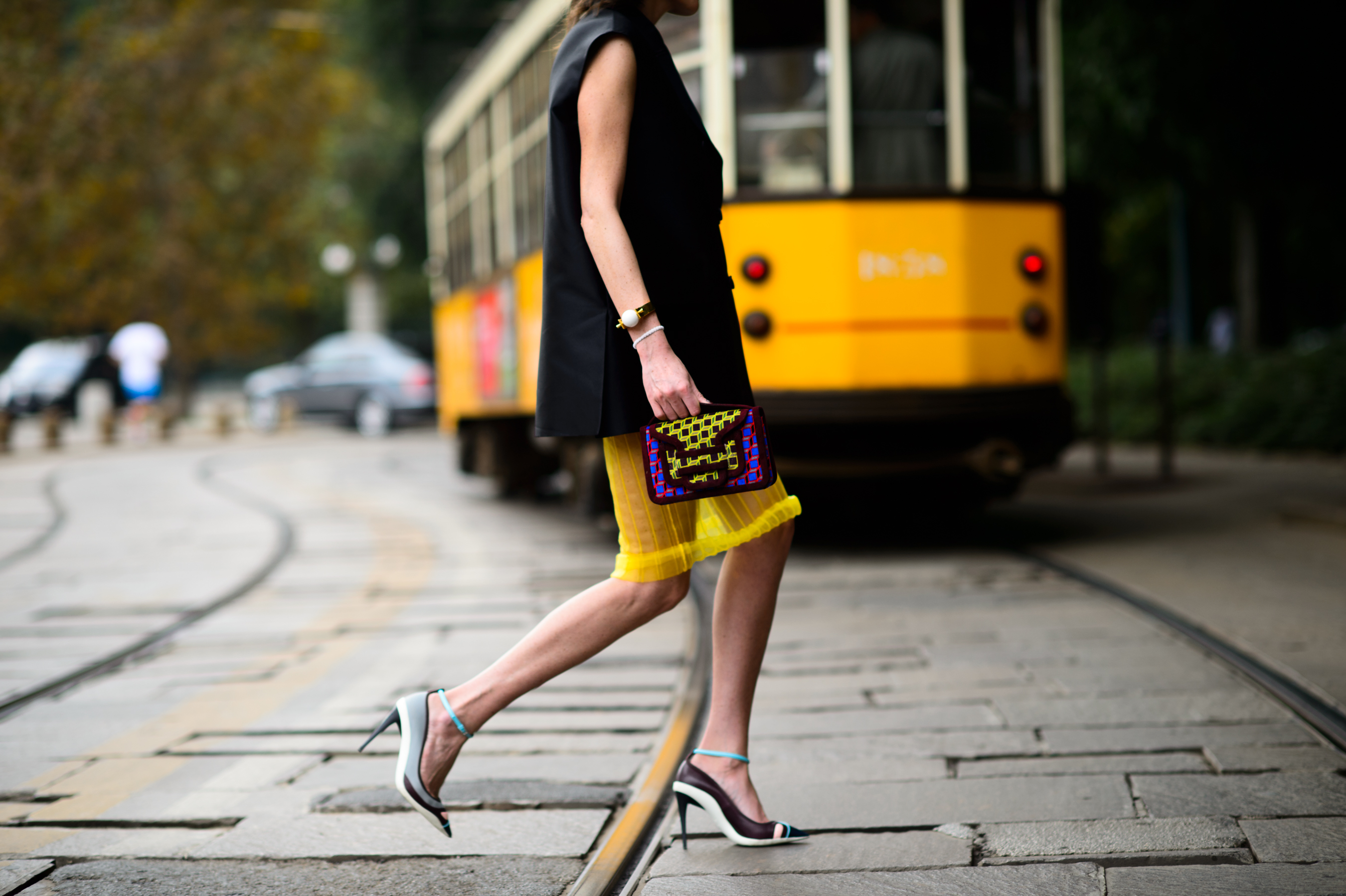 Woman running across the street in Italy