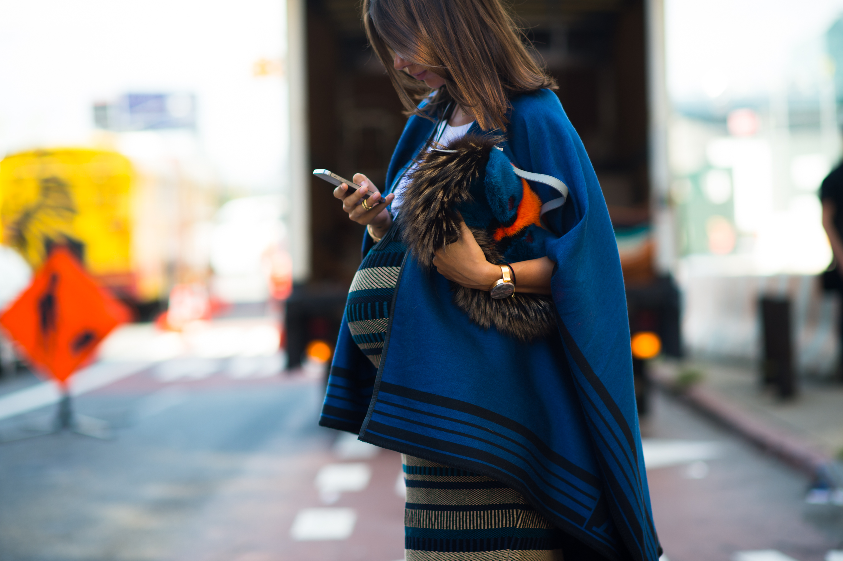 Pregnant Russian designer wearing a blue cape