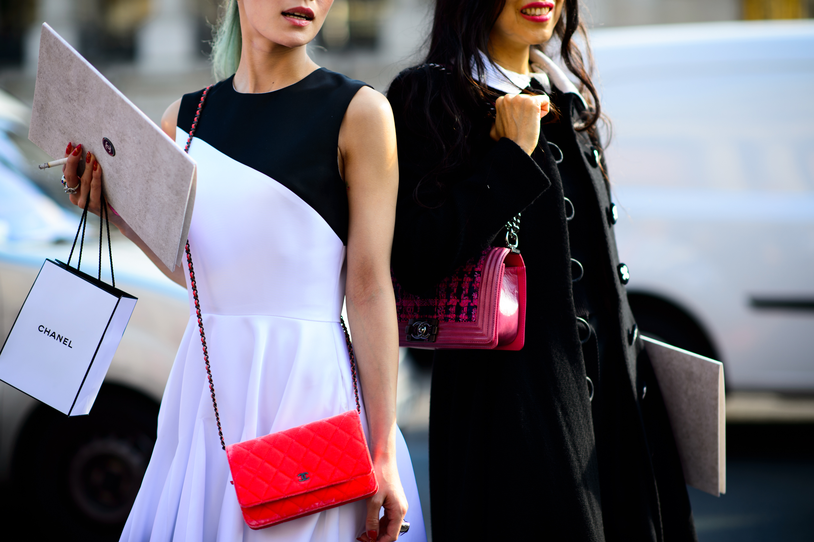 Two Japanese women with red and pink bags