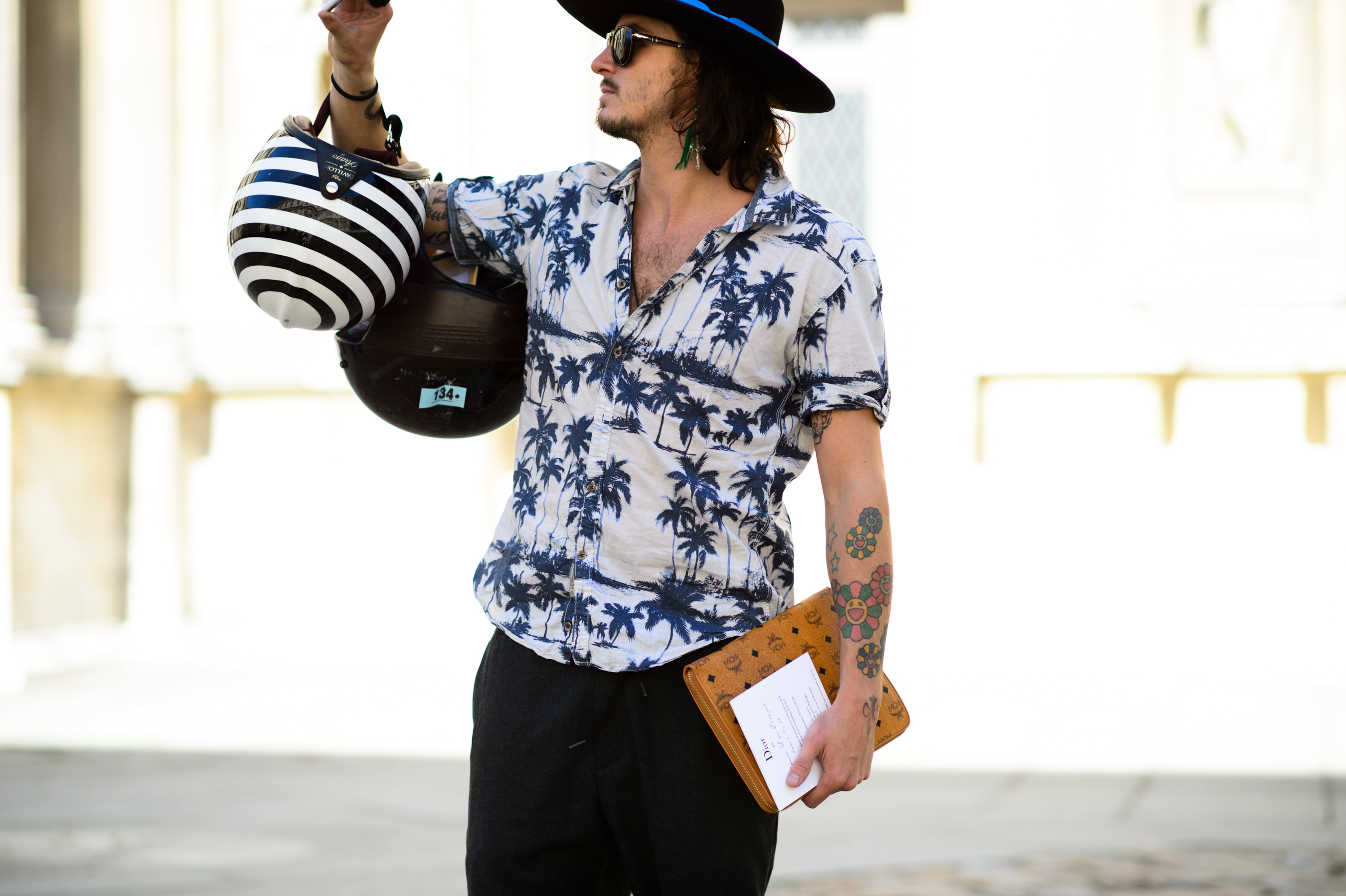 Man with two helmets in his hand