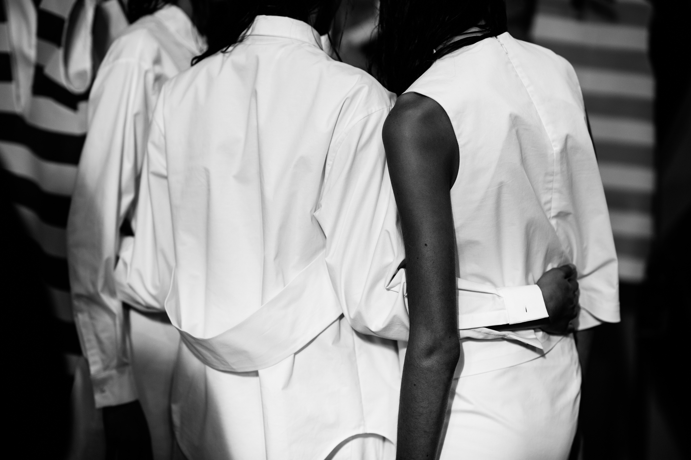 Three models wearing all white