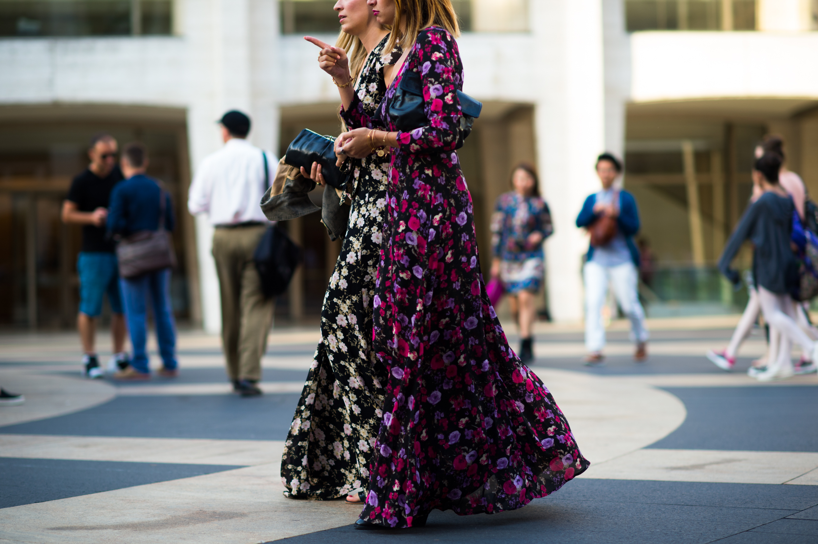 Two girls wearing floral dresses