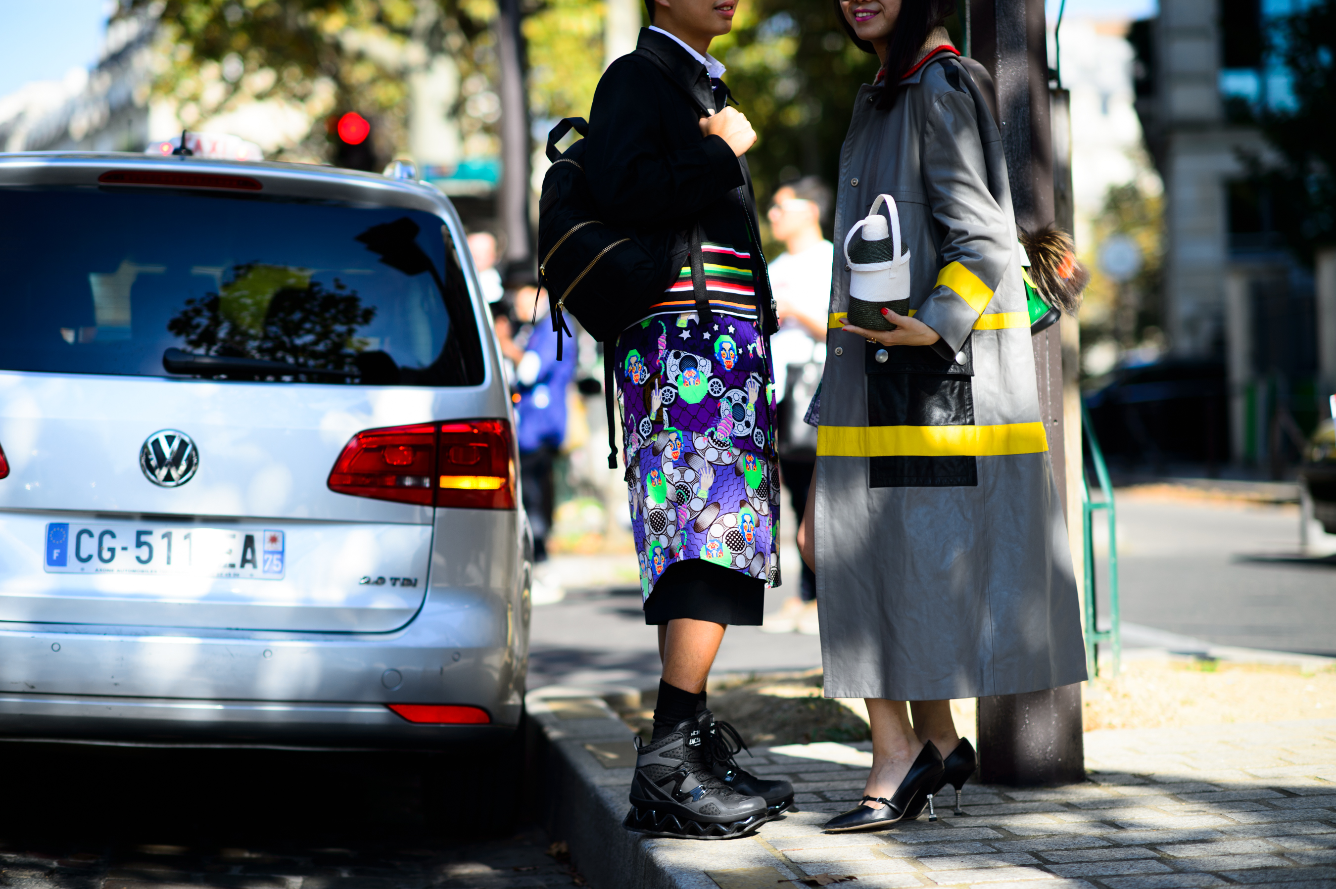 Two chinese people wearing bright colours