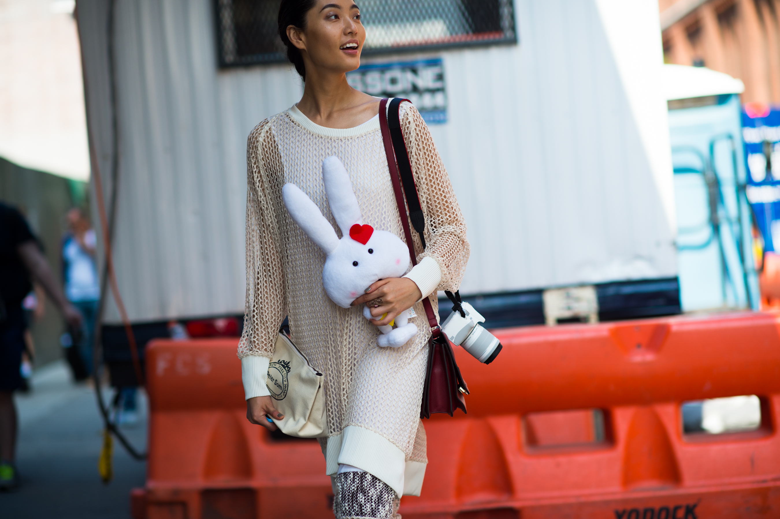 Chinese model carrying a stuffed animal