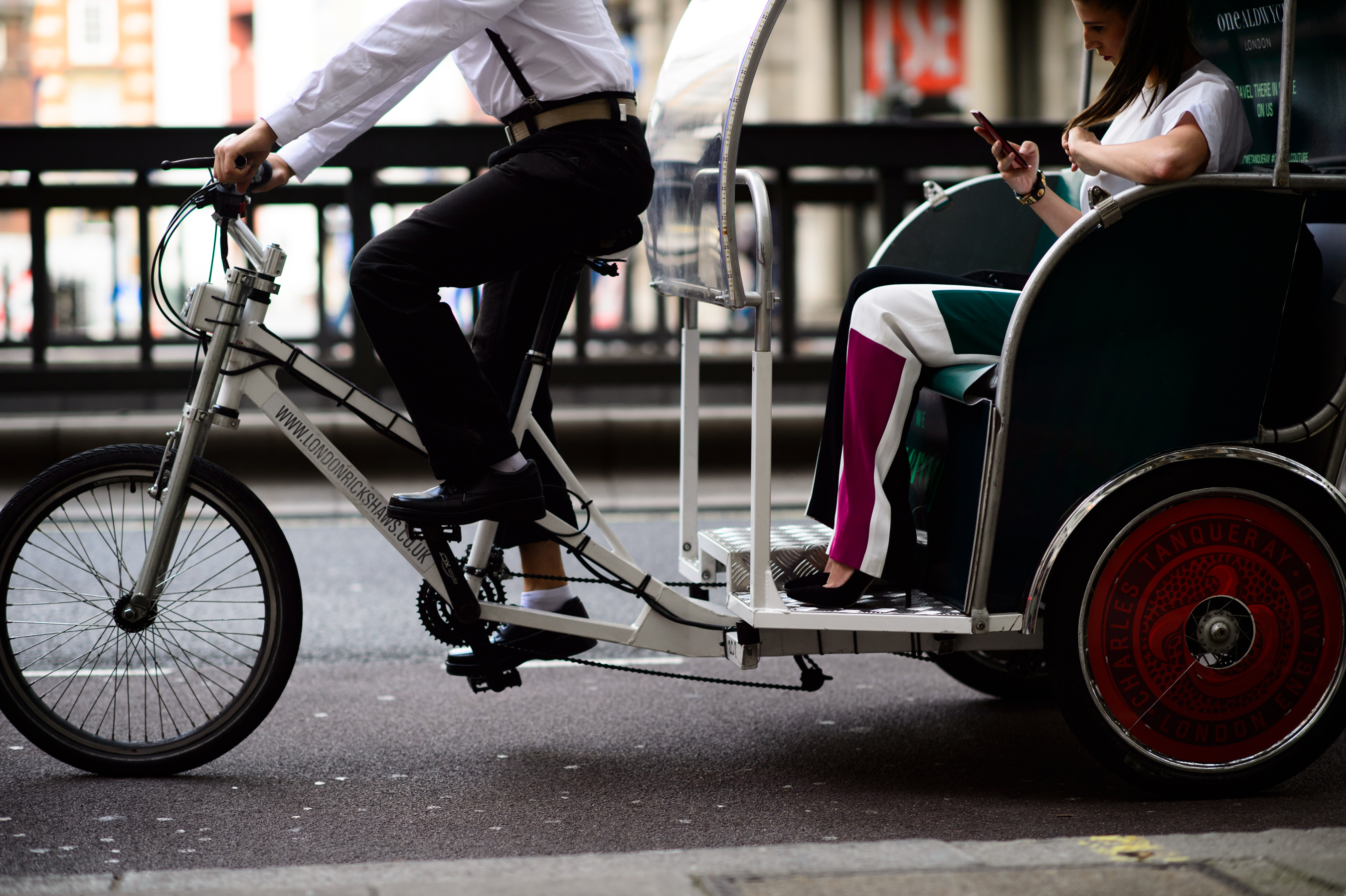 Woman riding in a bicycle rickshaw