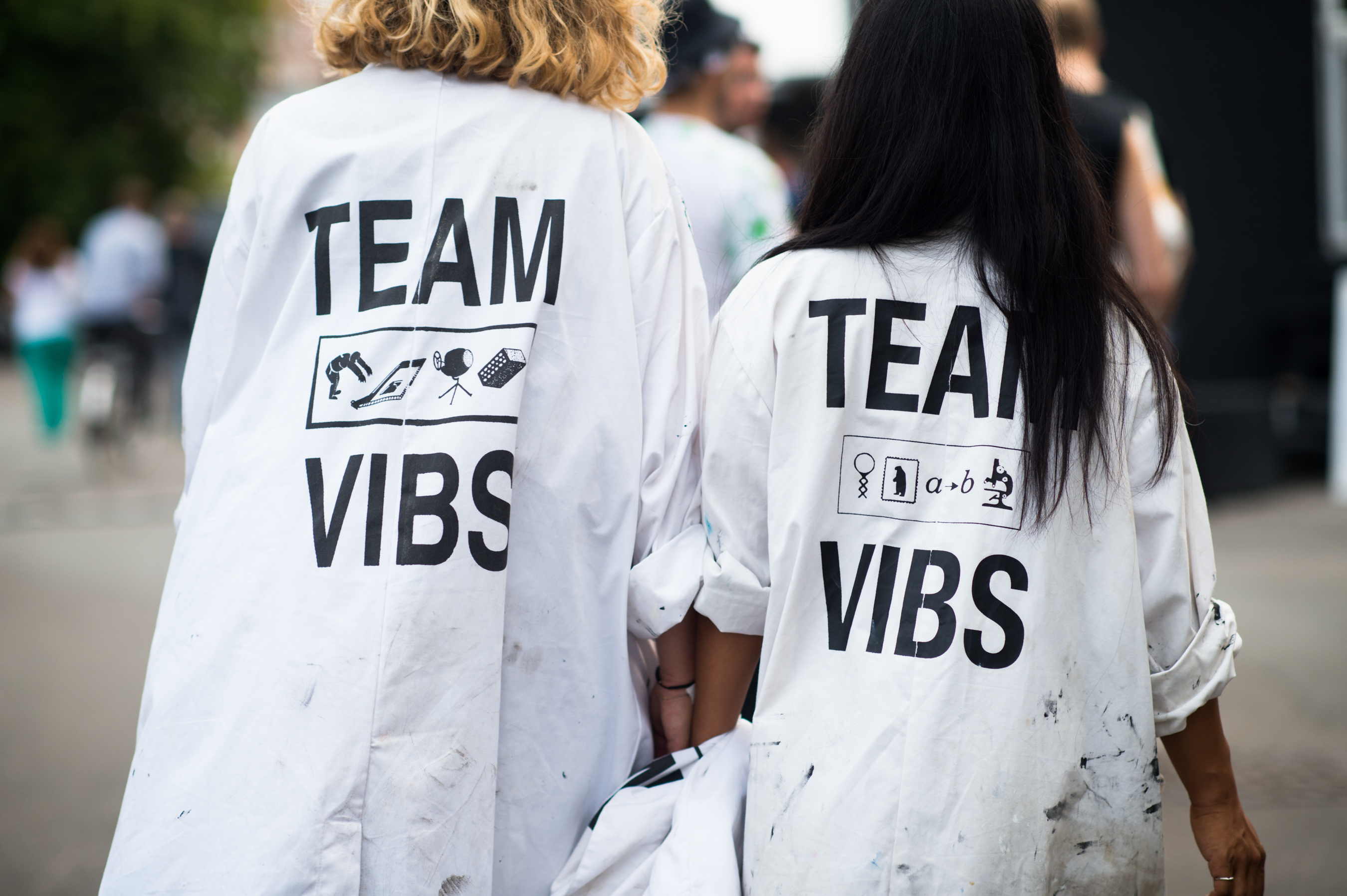Two girls wearing Team Vibs labcoats