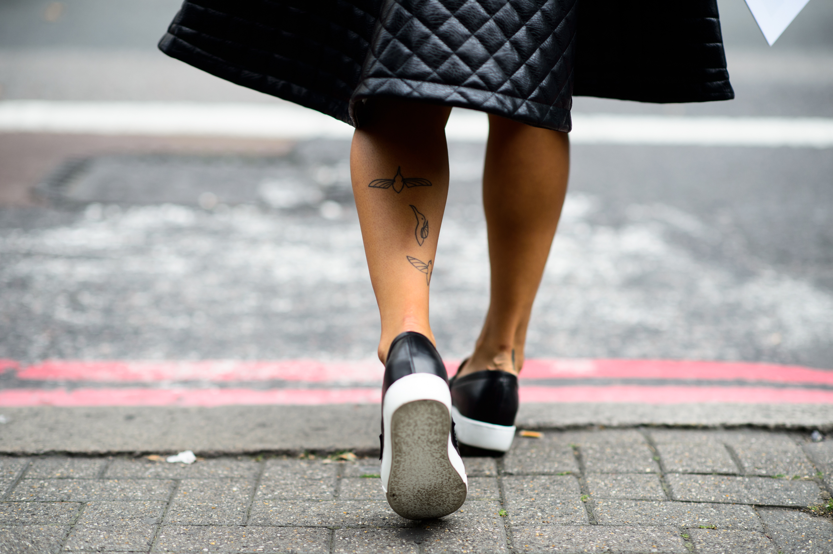 South Korean woman with hummingbird leg tattoos