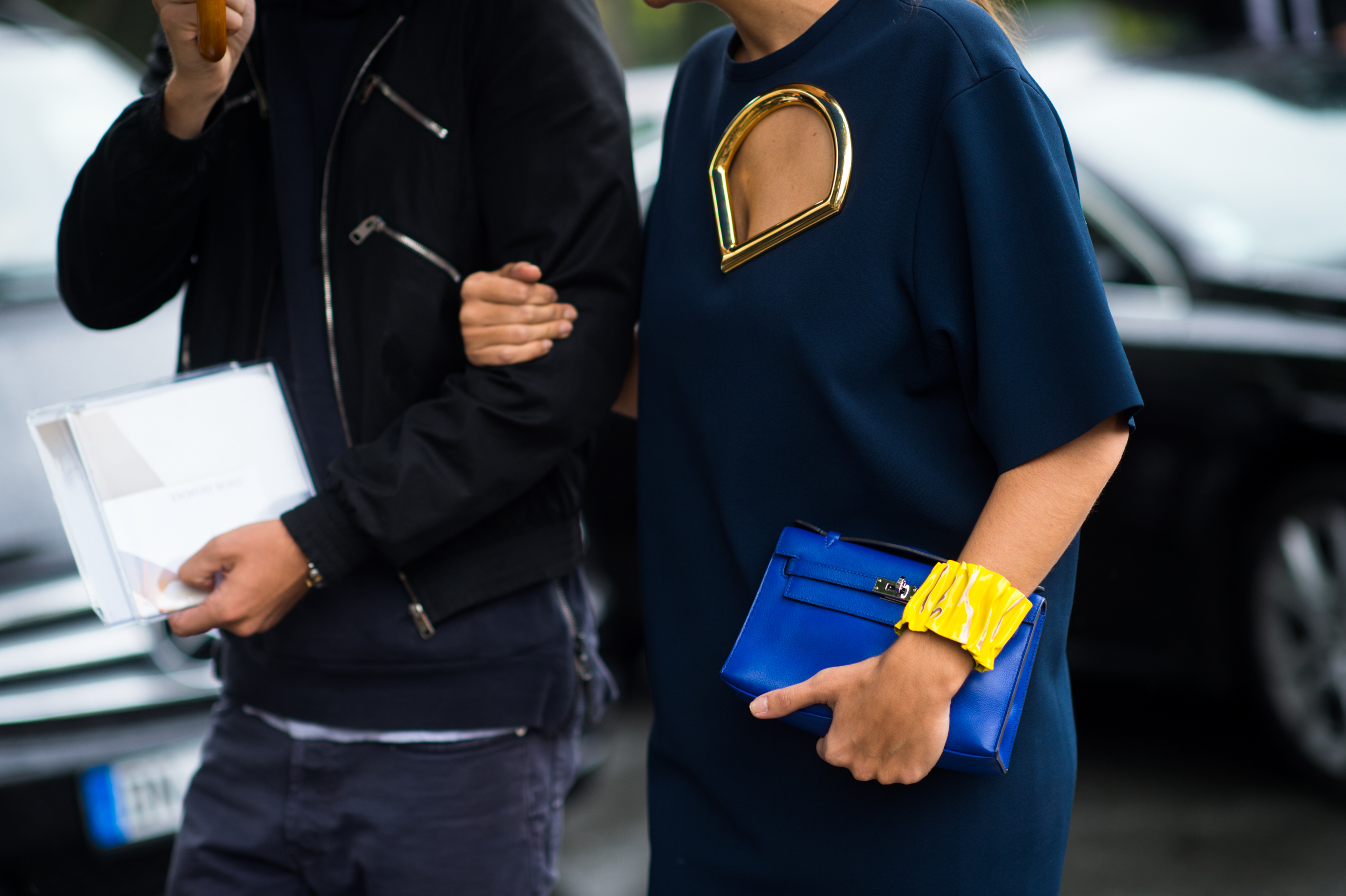 Woman holding a mans arm going to a fashion show
