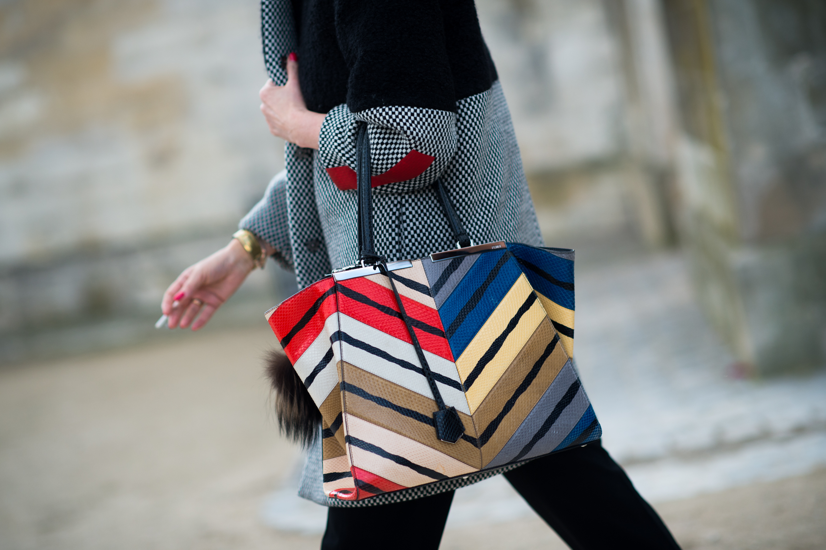 Woman carrying a striped Fendi bag
