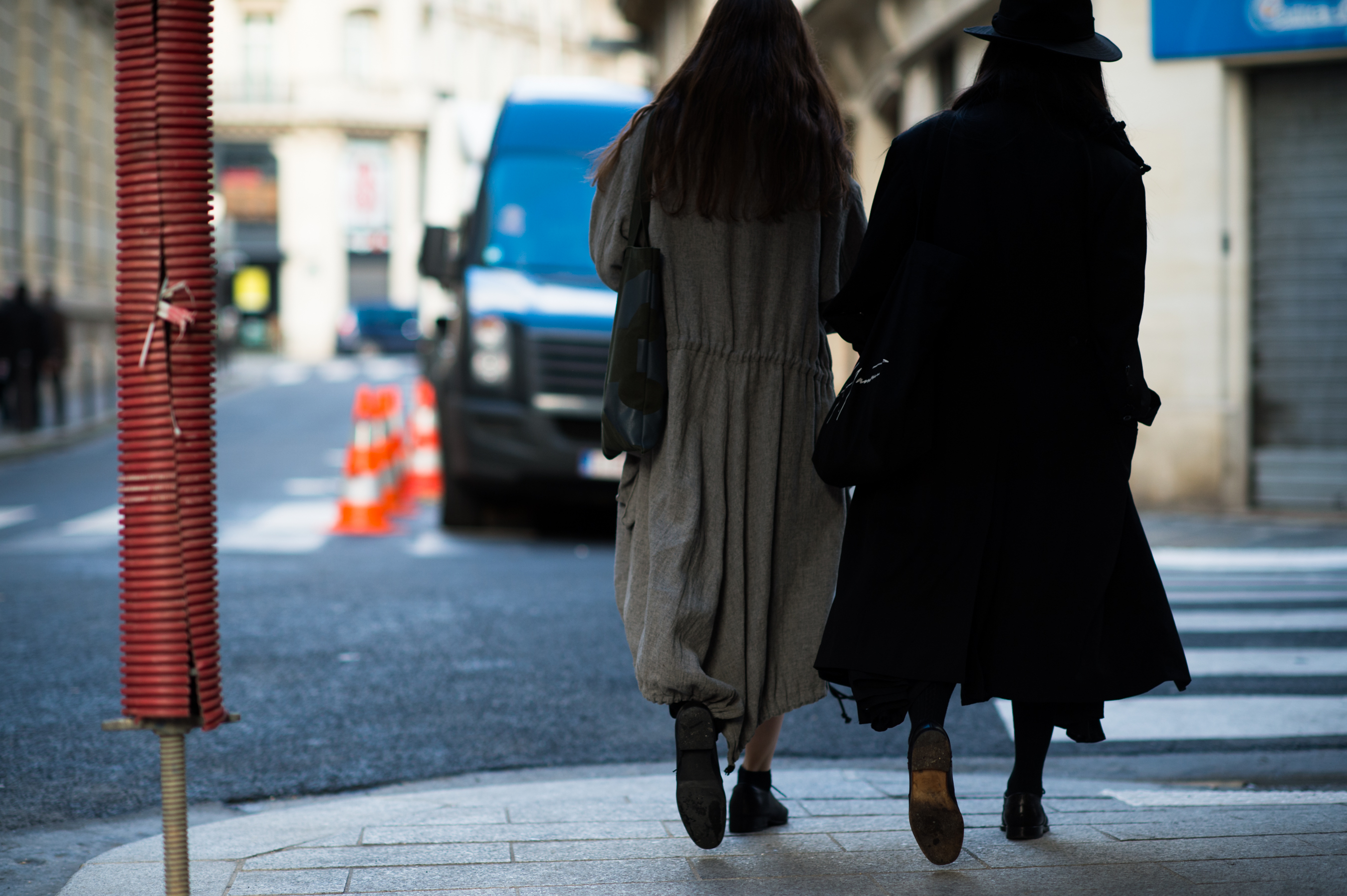 Two women wearing long coats