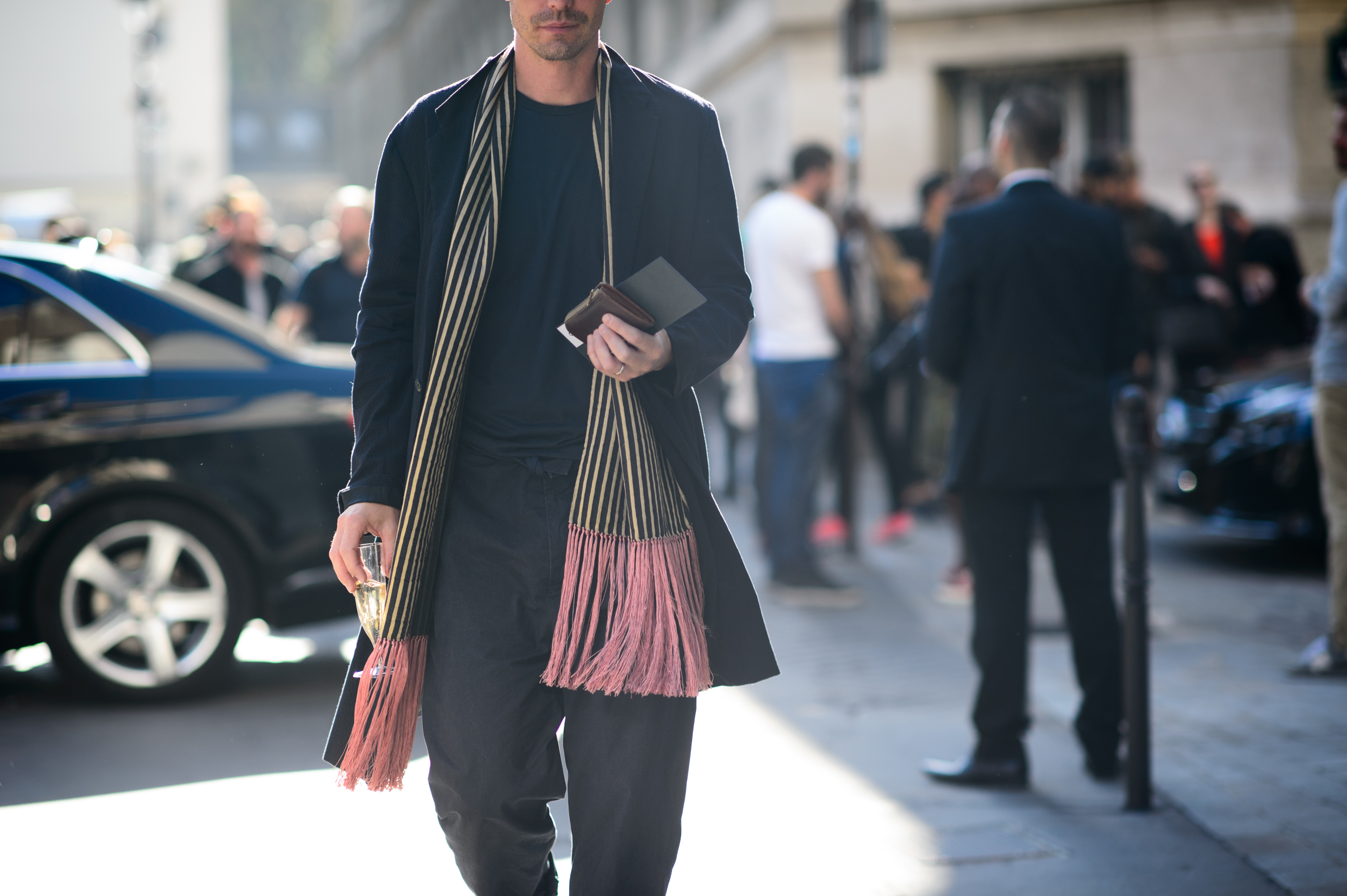 Man drinking champagne after a fashion show