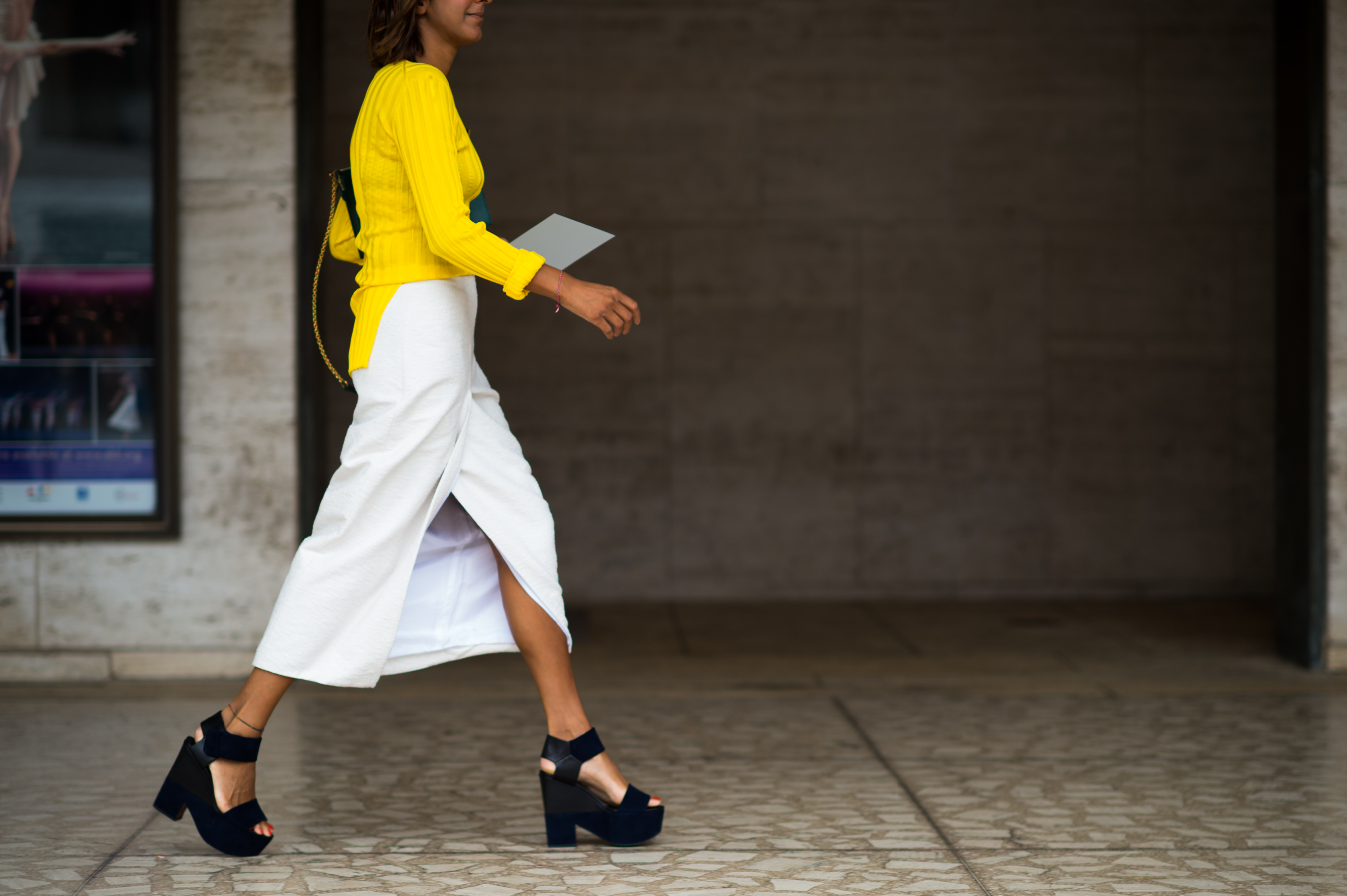 Woman wearing a yellow top and white skirt