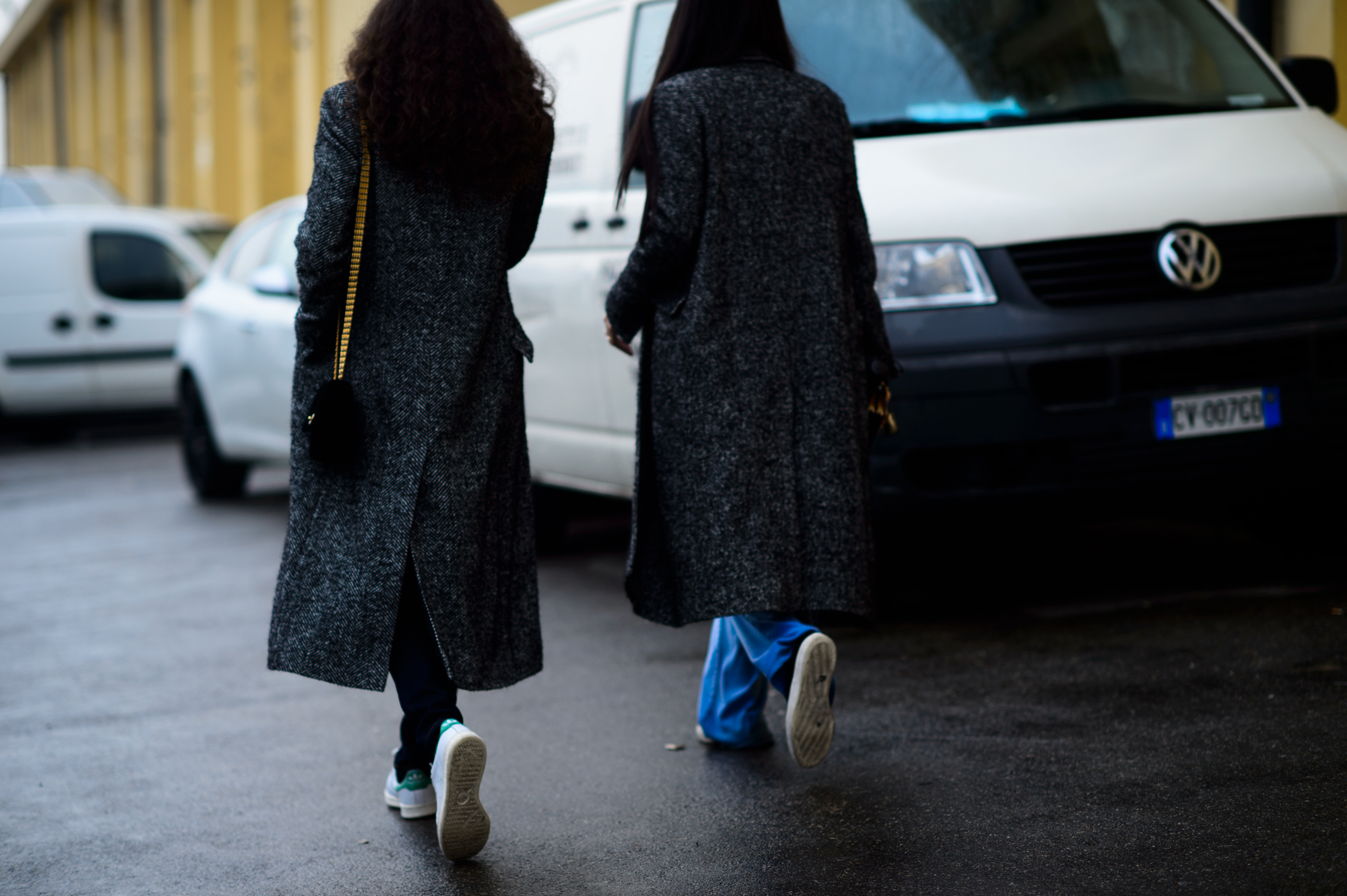Two Italian women wearing matching grey coats