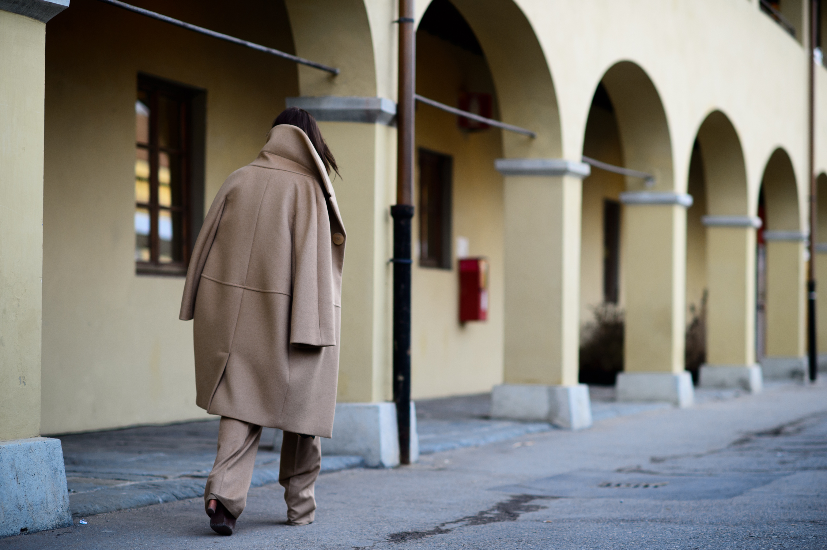 Woman wearing an oversized camel coat