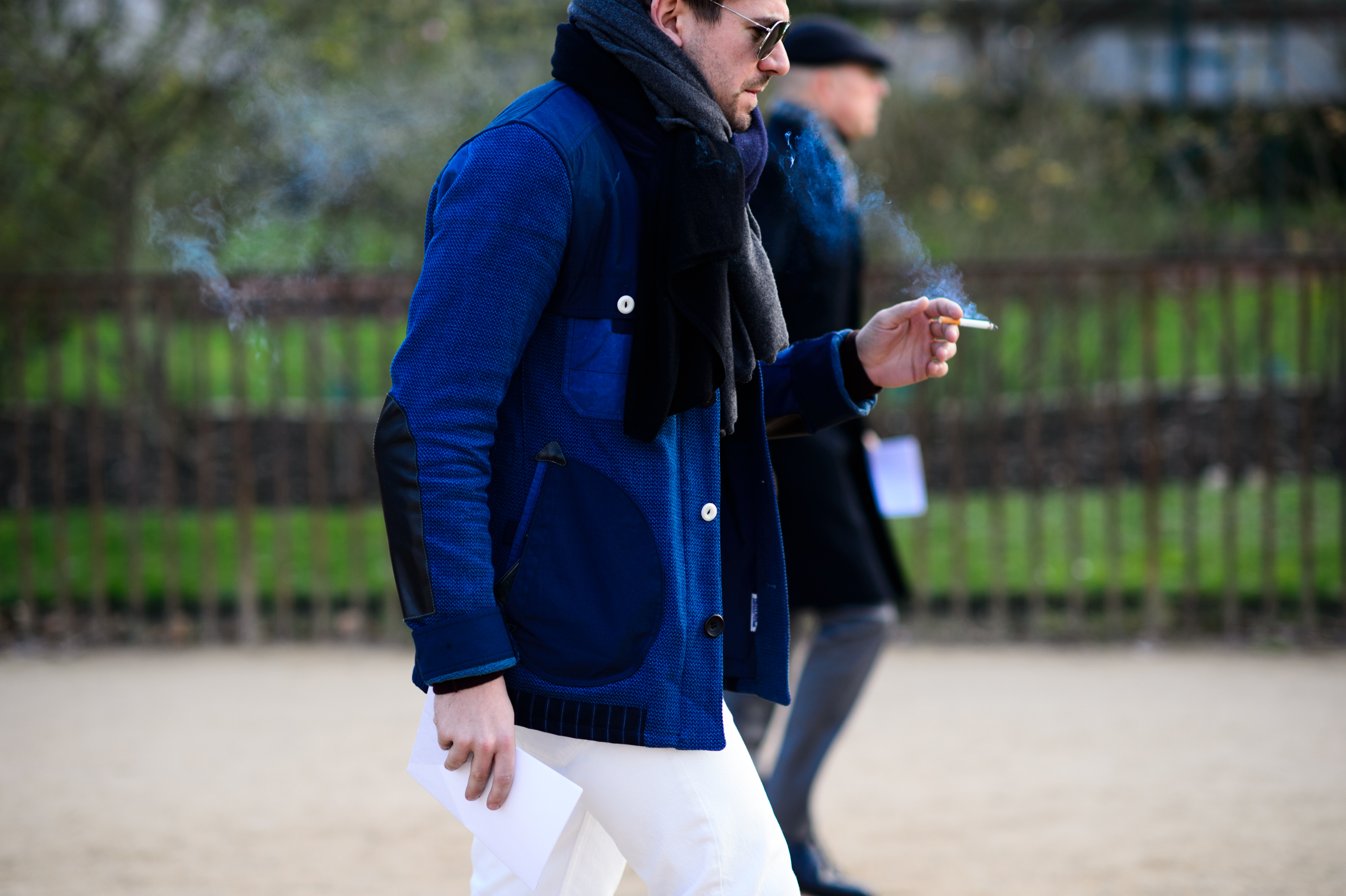 Man smoking and wearing a blue jacket