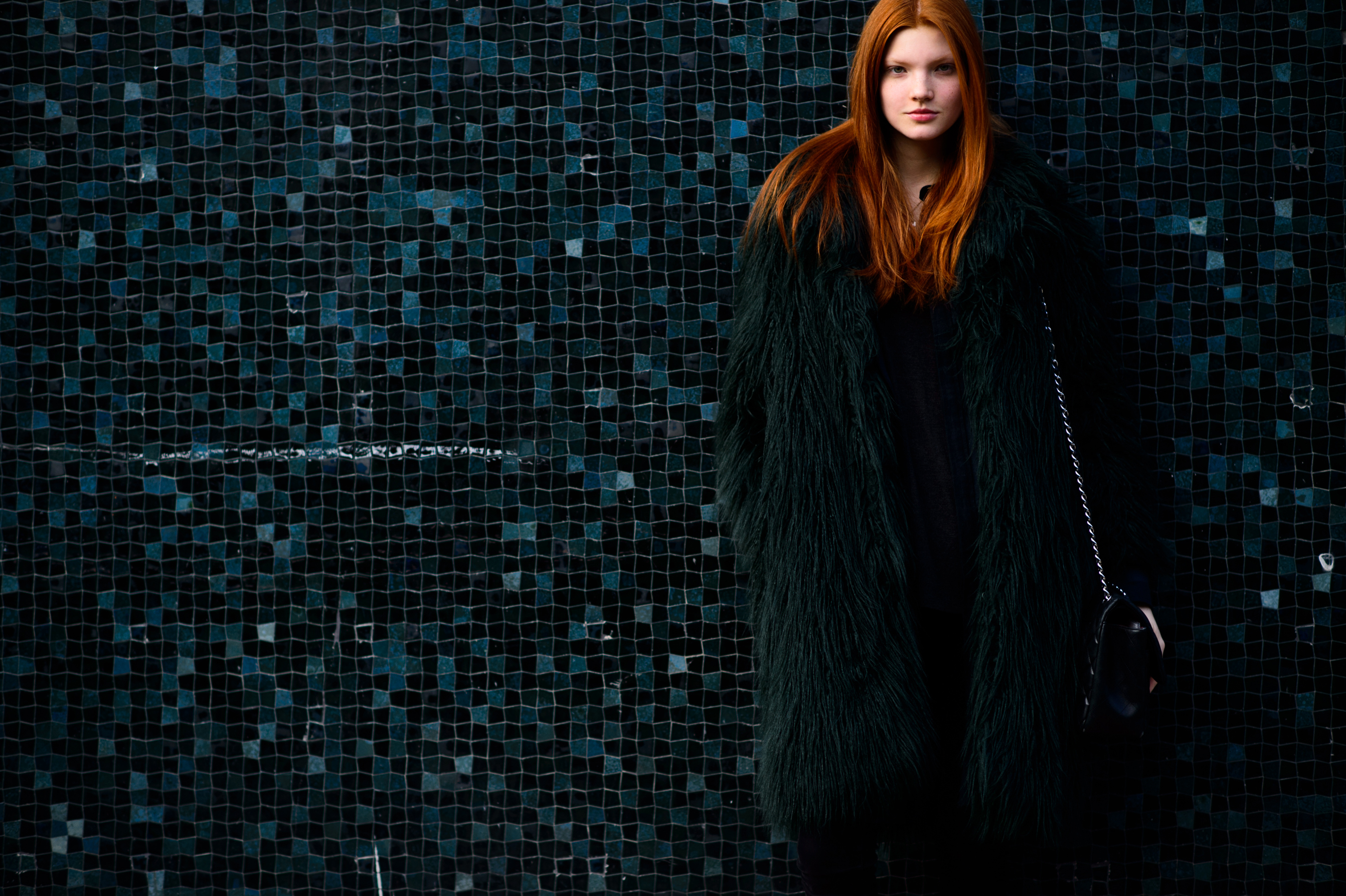Russian redhead model and a green mosaic wall