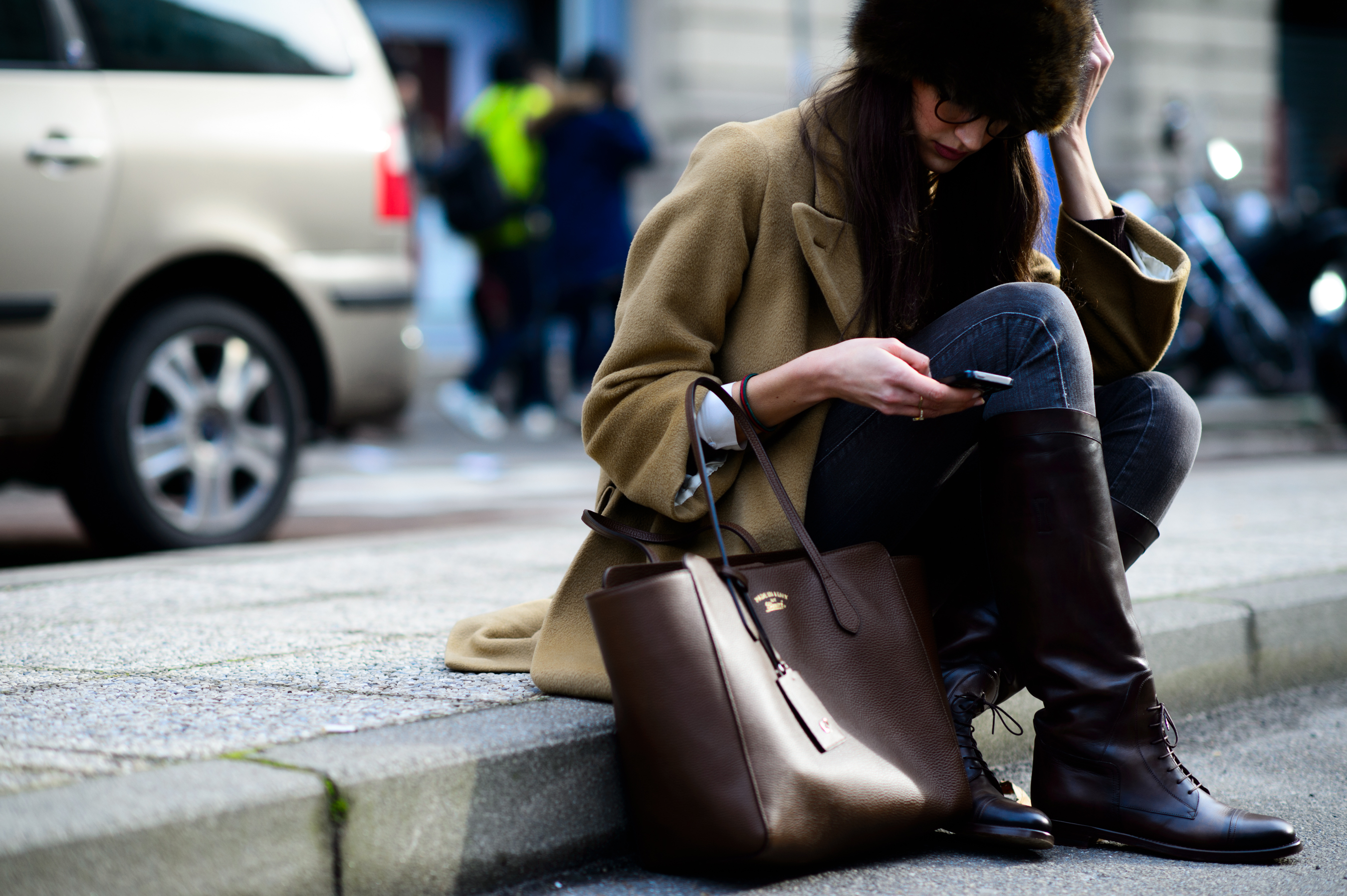 Italian girl sitting on the sidewalk