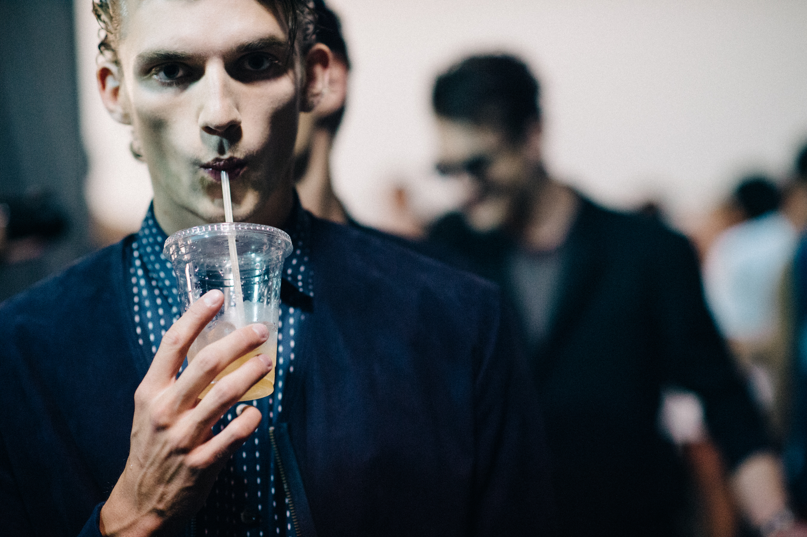 Male model drinking iced coffee