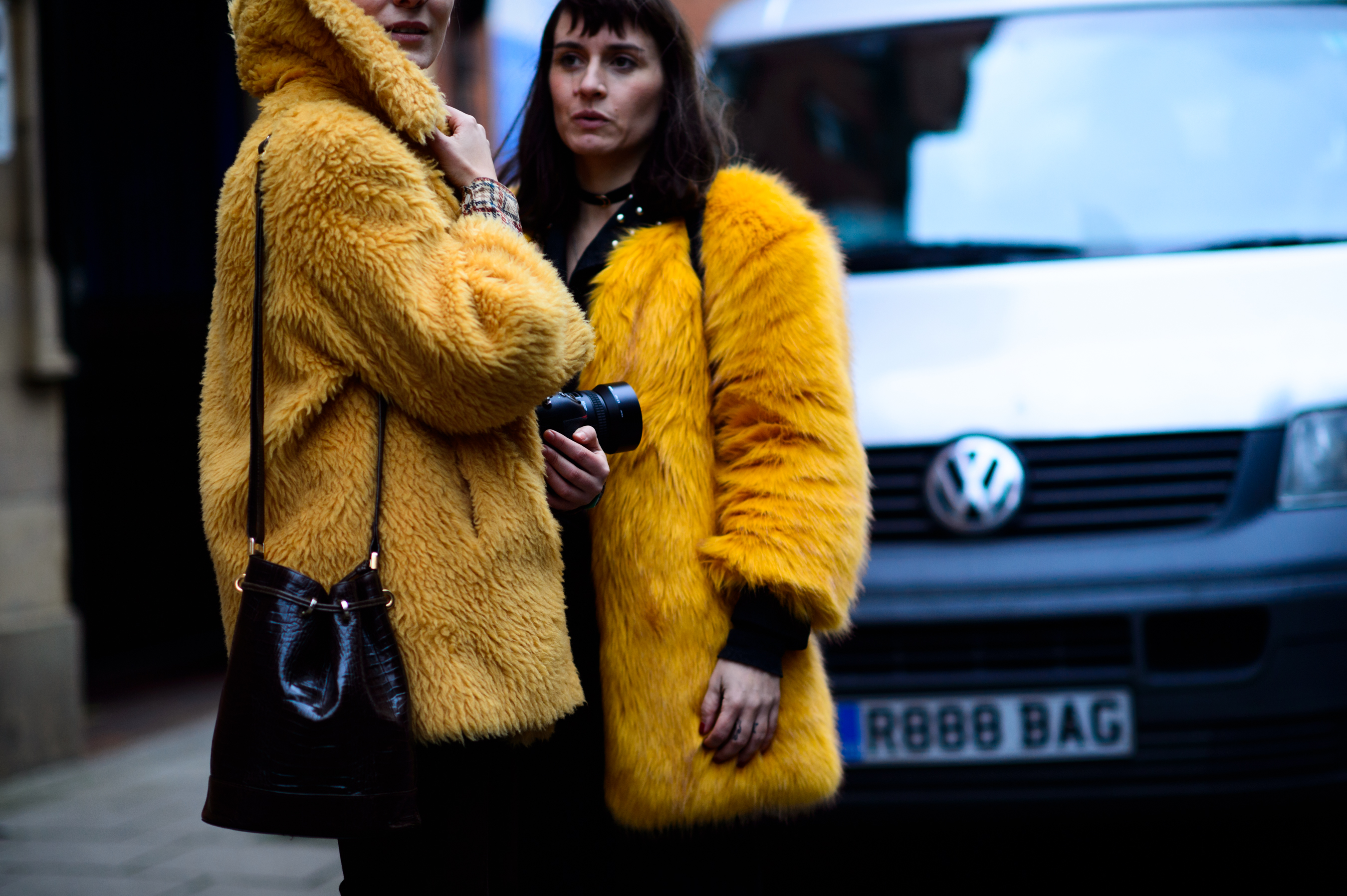 Romanian and Italian women wearing yellow coats