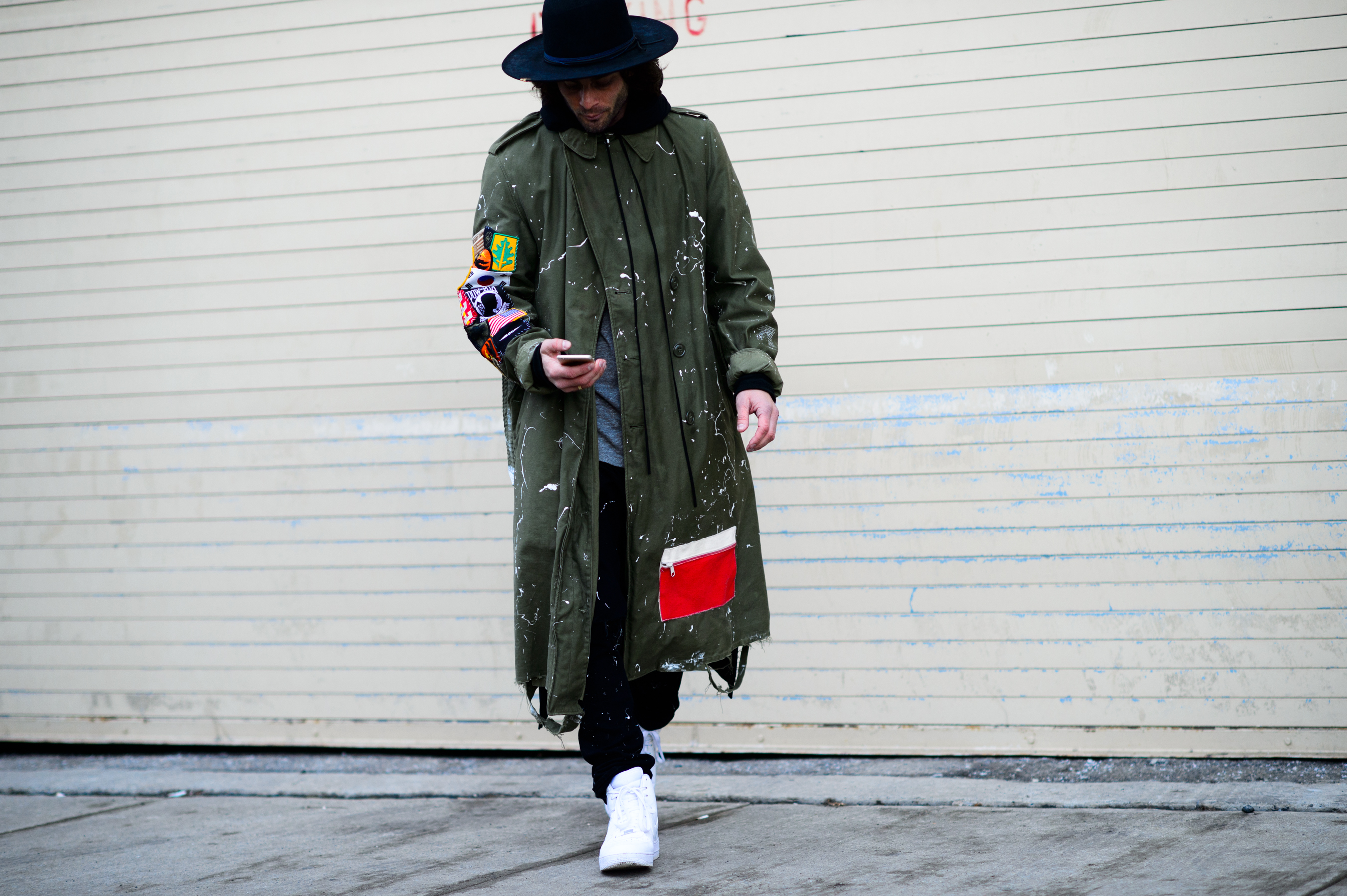 Man wearing a paint-splattered coat
