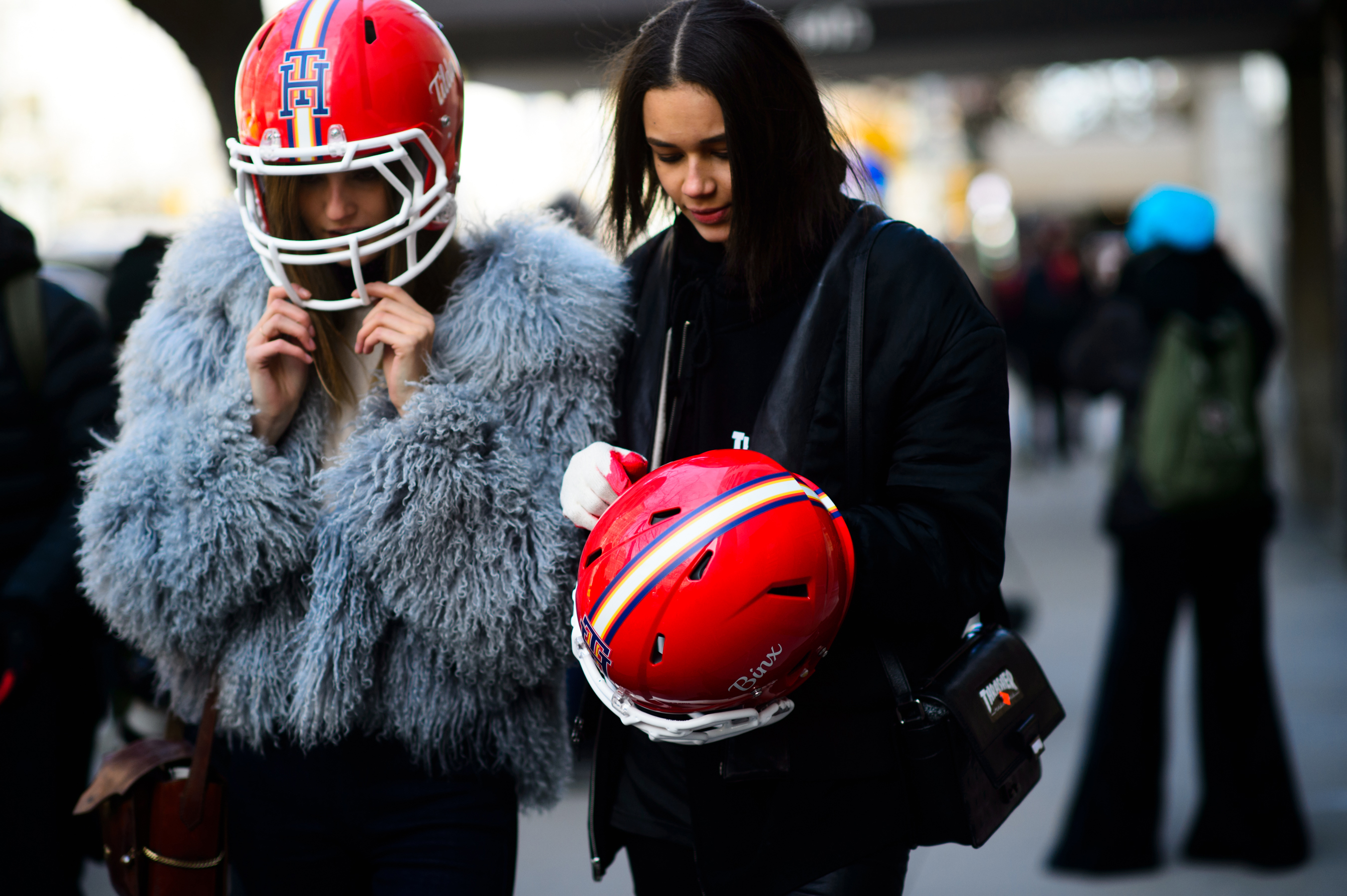 Two models with Tommy Hilfiger football helemets