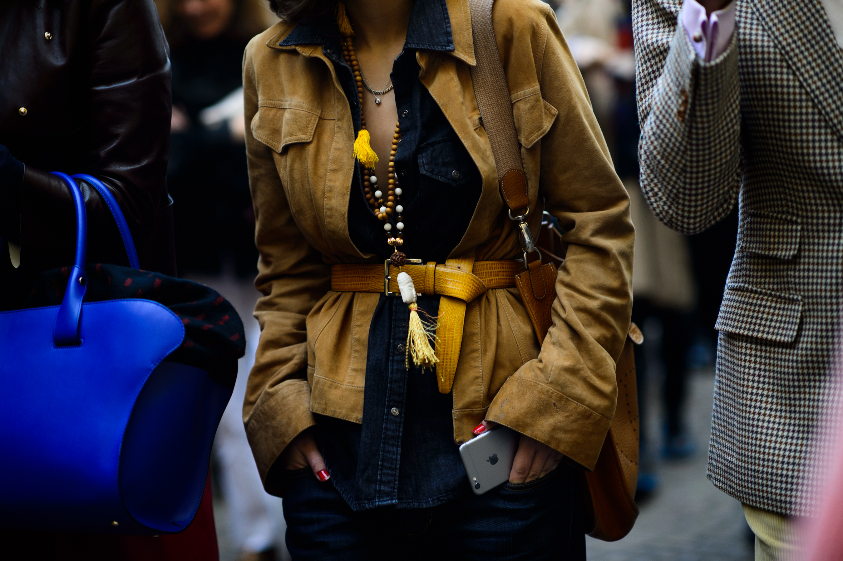 Woman wearing a belted suede jacket