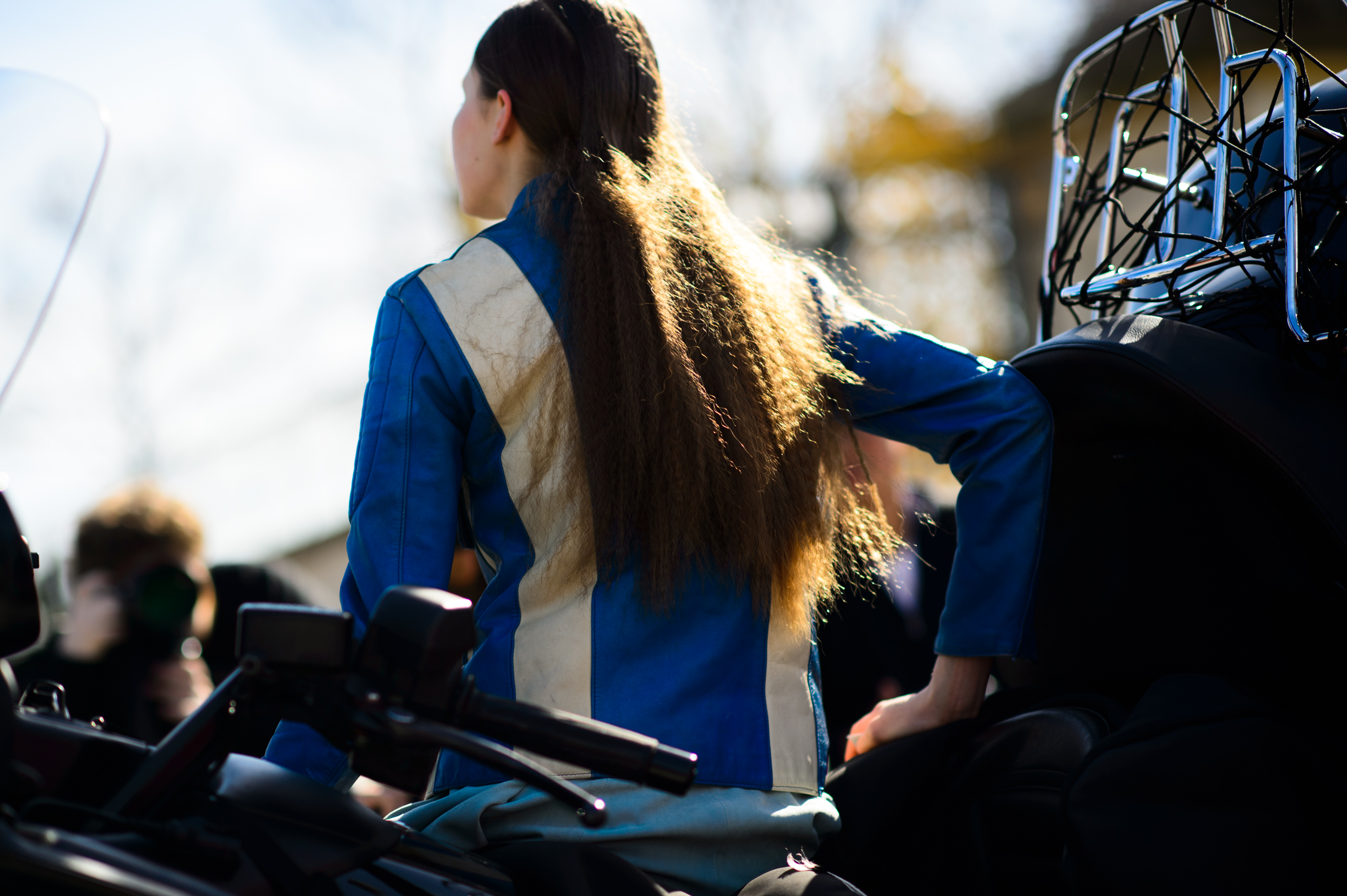 Model with crimped hair on a scooter
