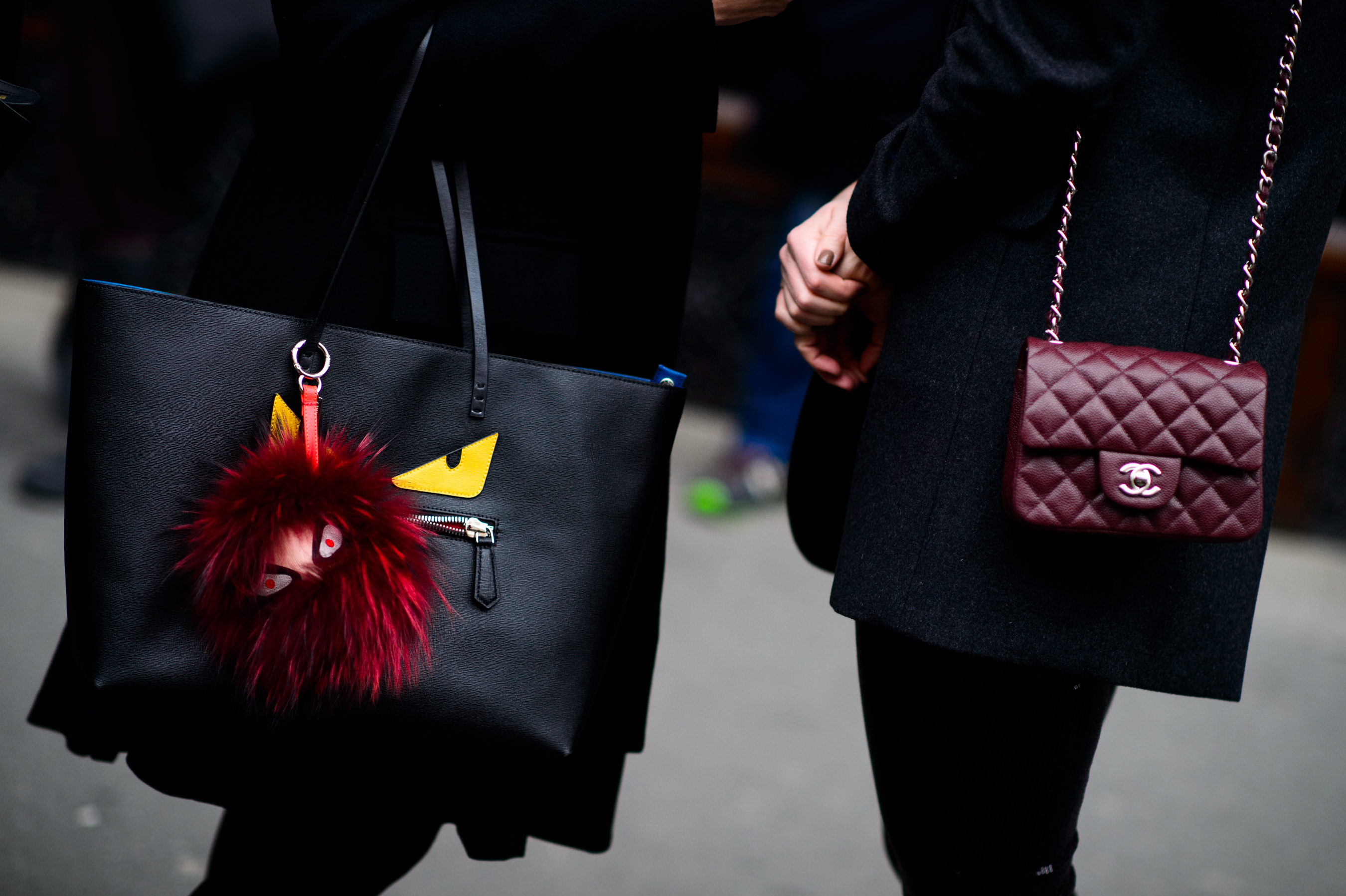 Woman with a Fendi face bag and a Chanel bag