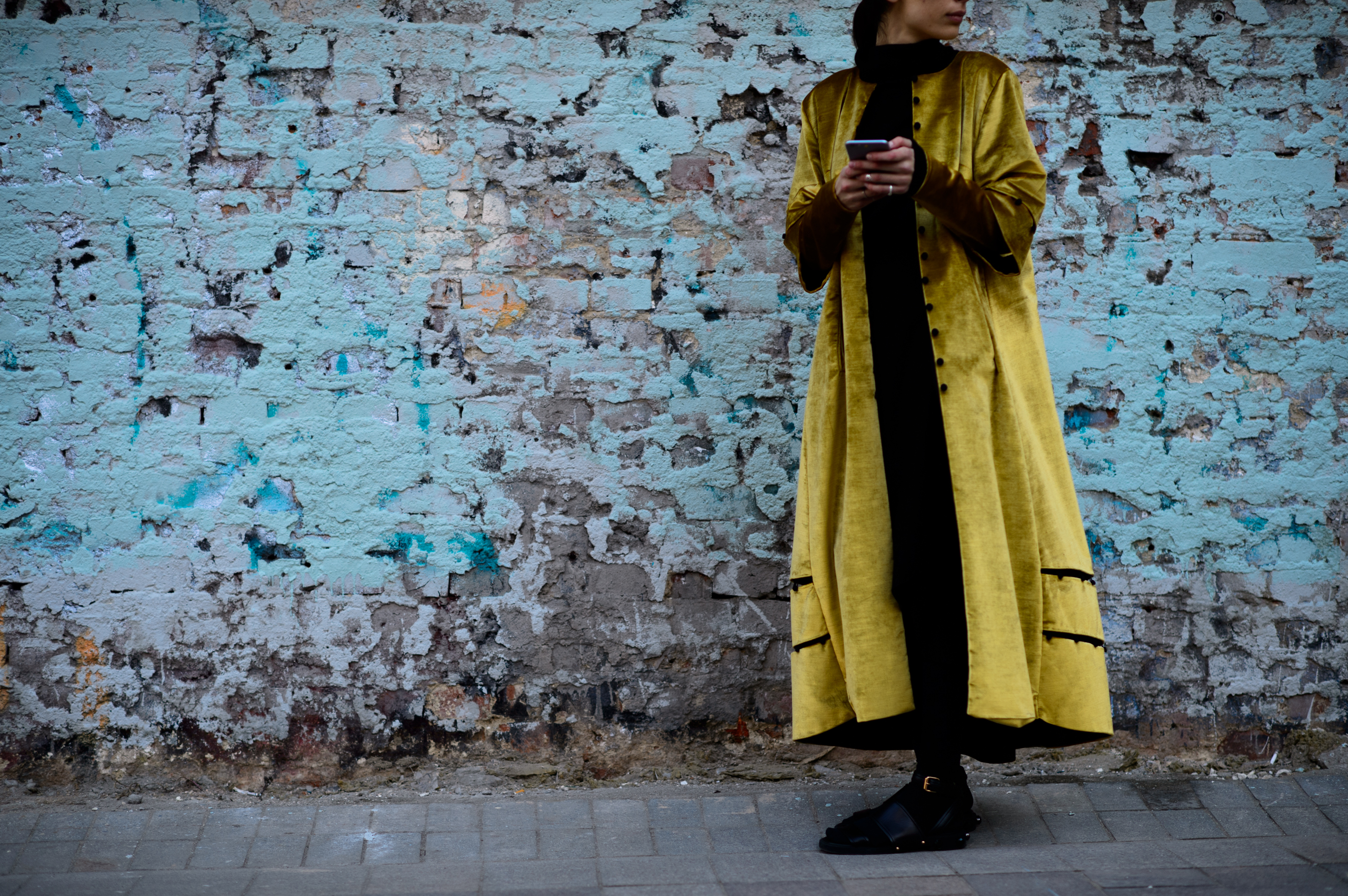 Georgian woman wearing a gold coat and Givenchy sandals