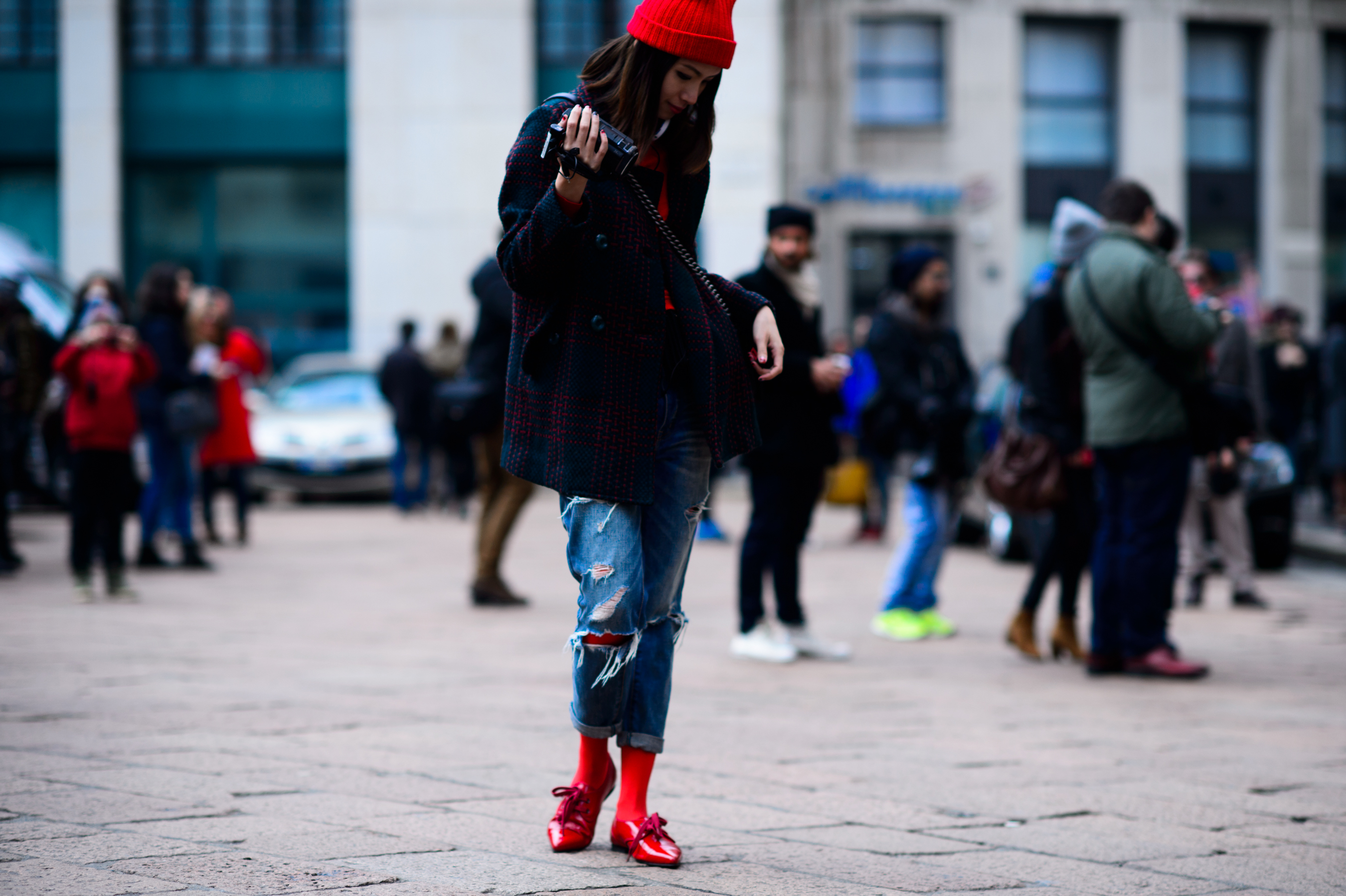 Asian girl with a camcorder and red shoes