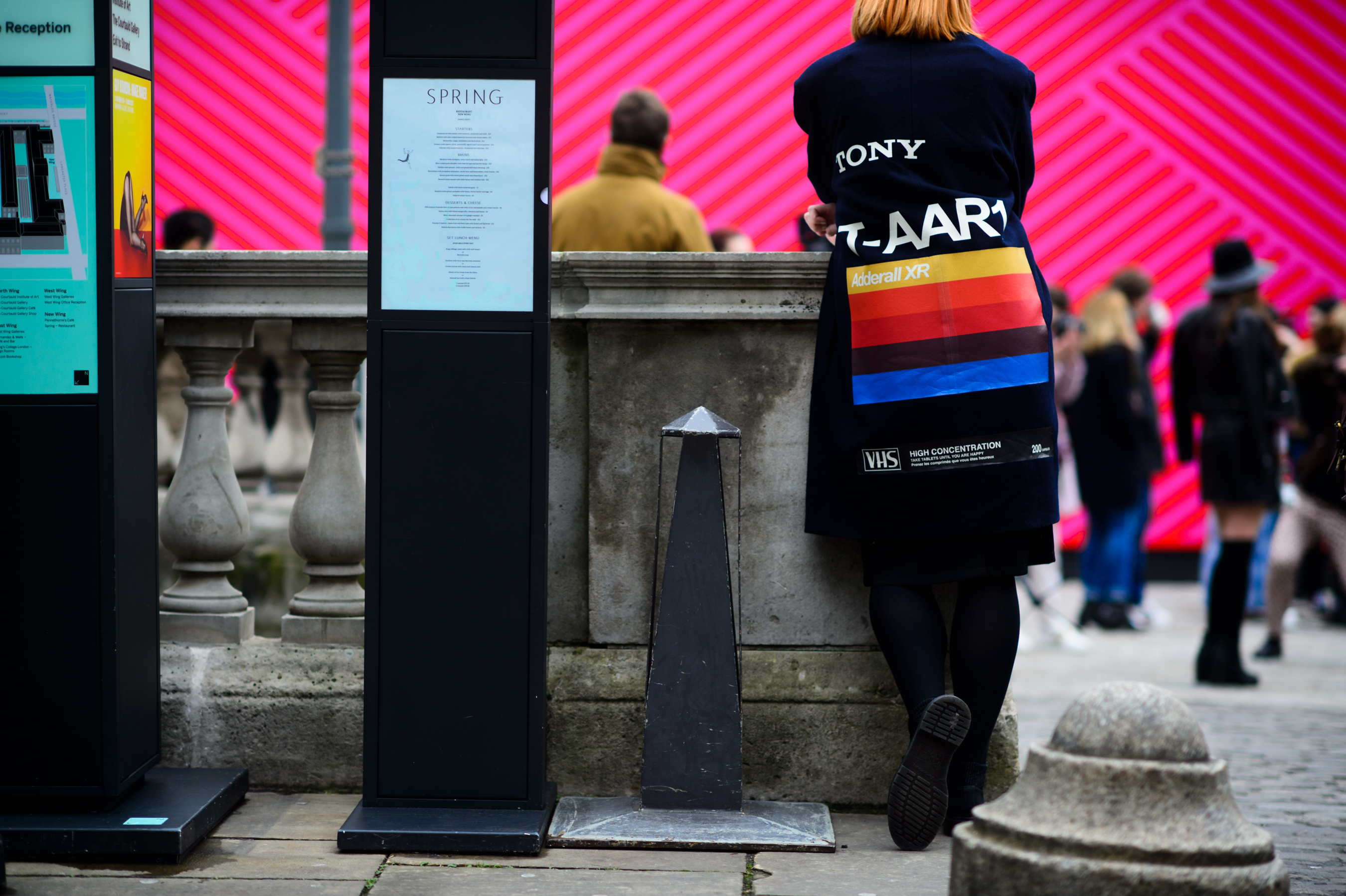 Woman wearing a VHS parody coat