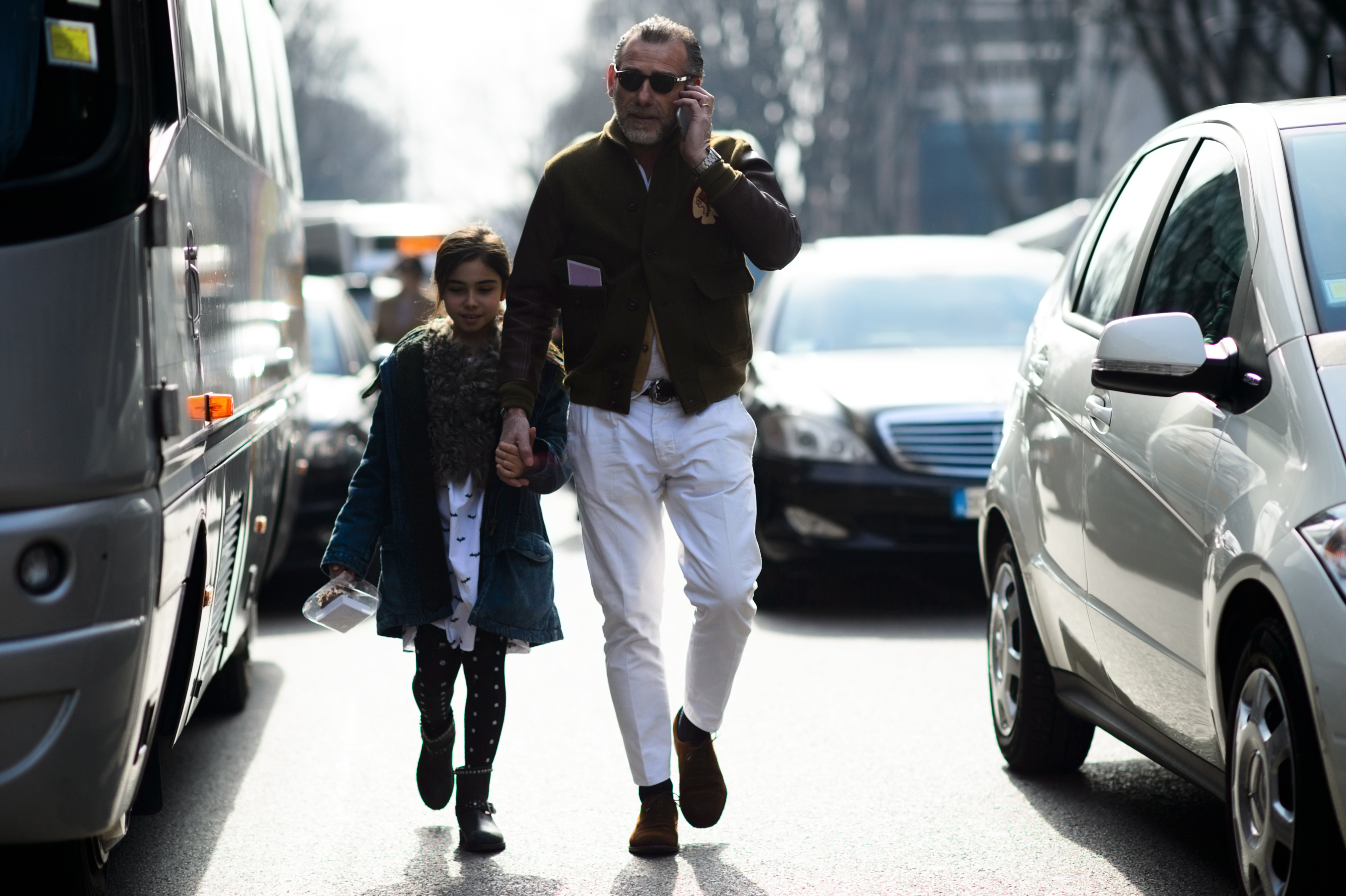 Italian man walking with his daughter