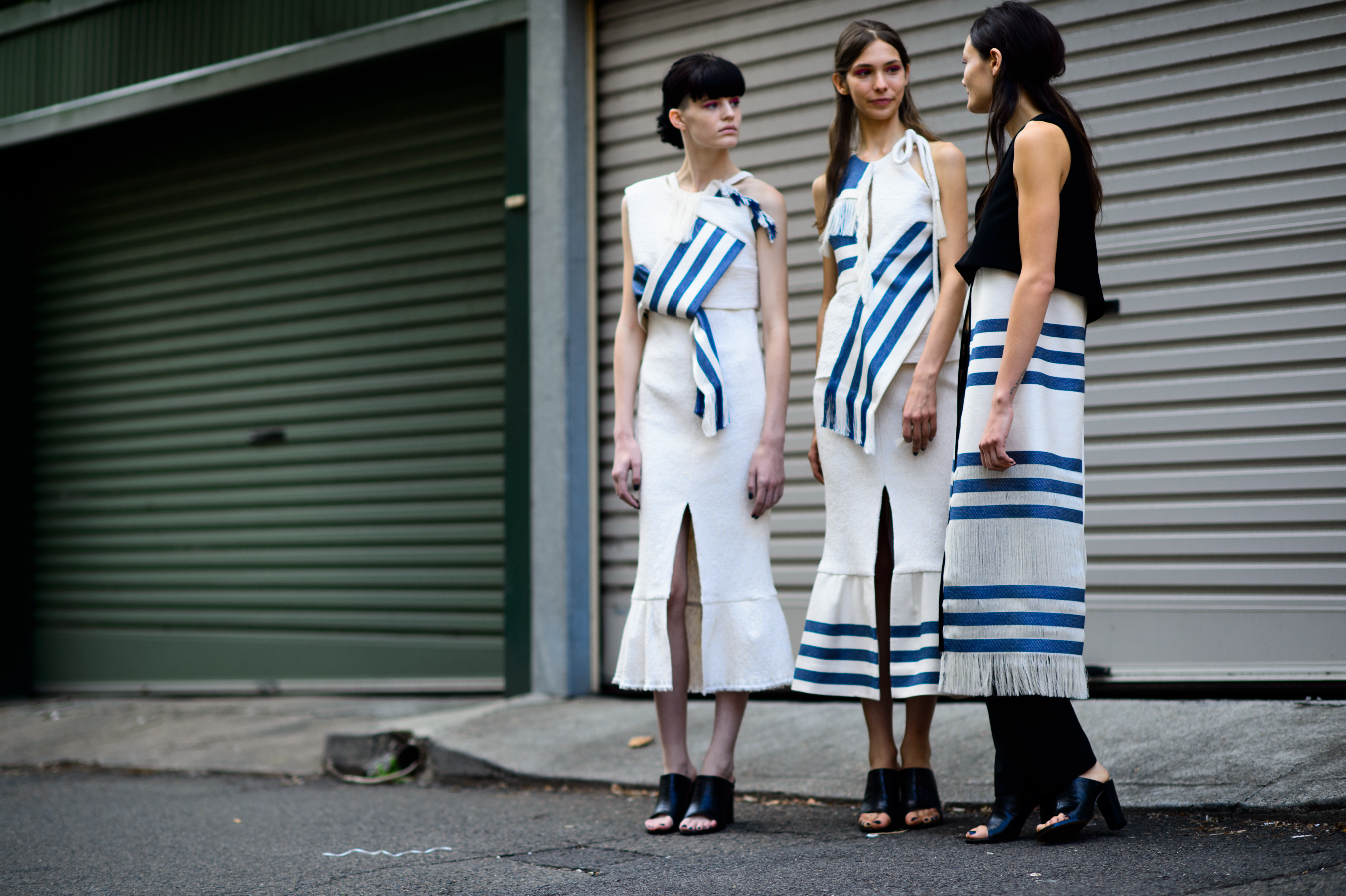 Three models wearing striped dresses