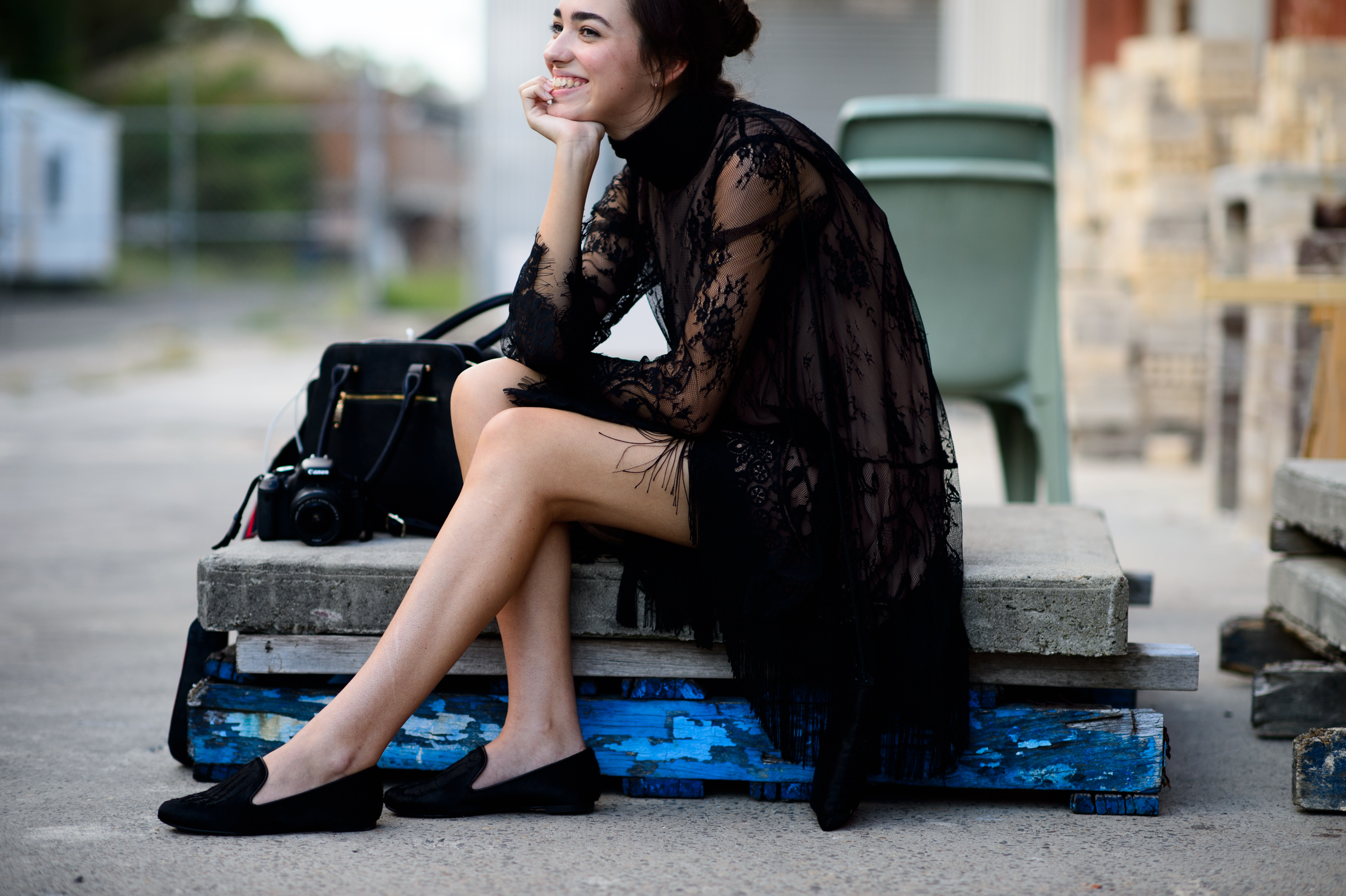 Girl sitting in a black lace dress