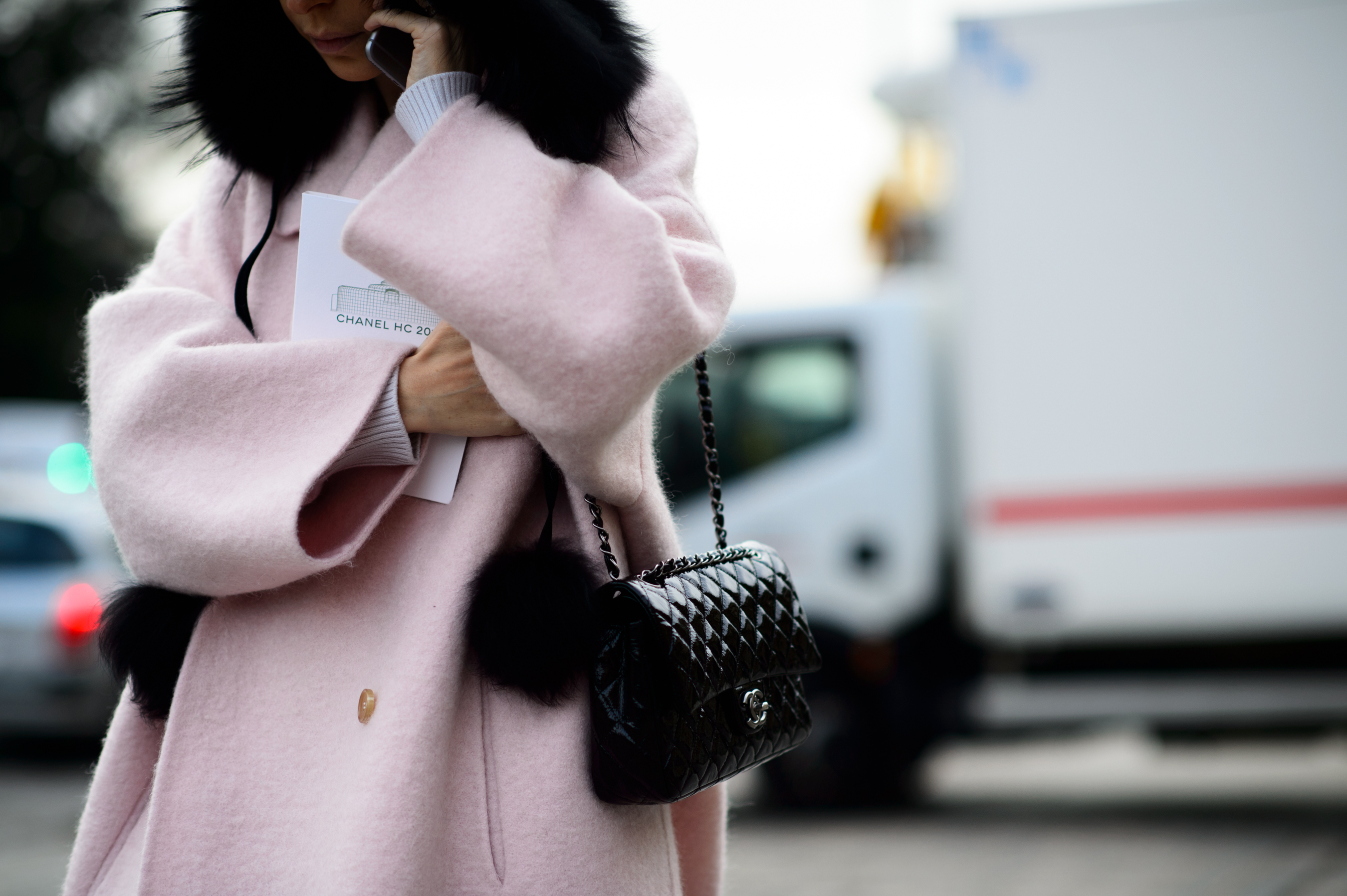 Woman wearing a fur hat and a pink coat