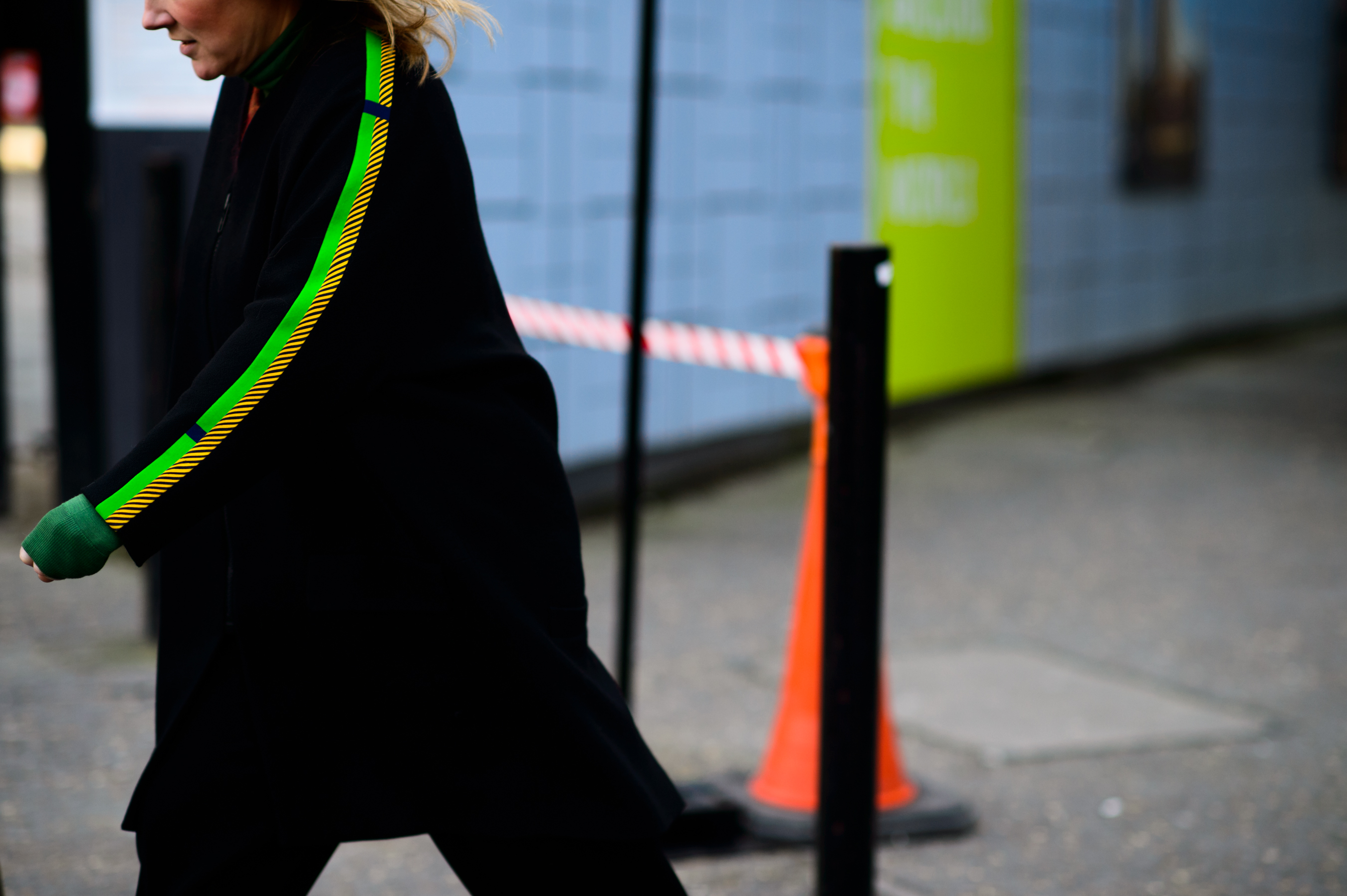 Woman wearing a black green and yellow coat