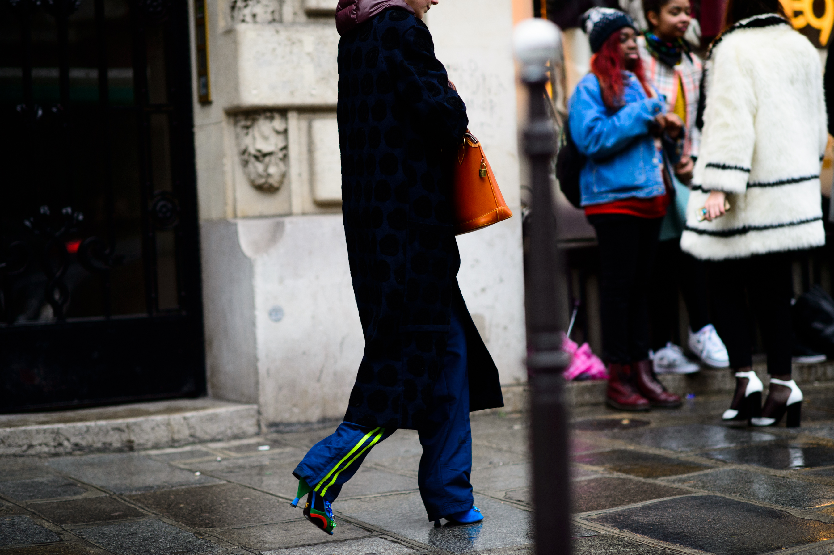 Stylist wearing rainbow Prada shoes and track pants
