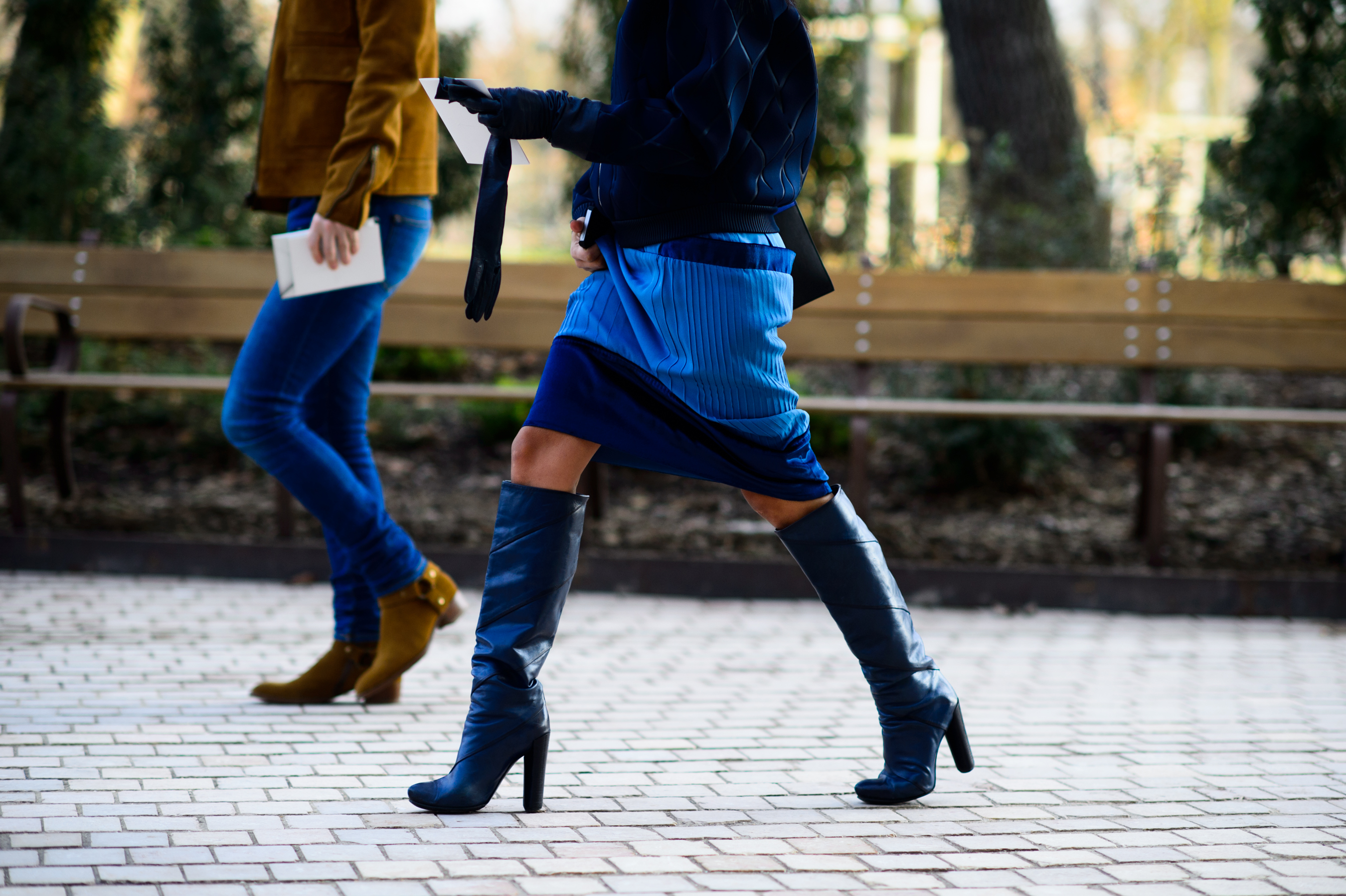 Woman wearing a blue skirt and boots