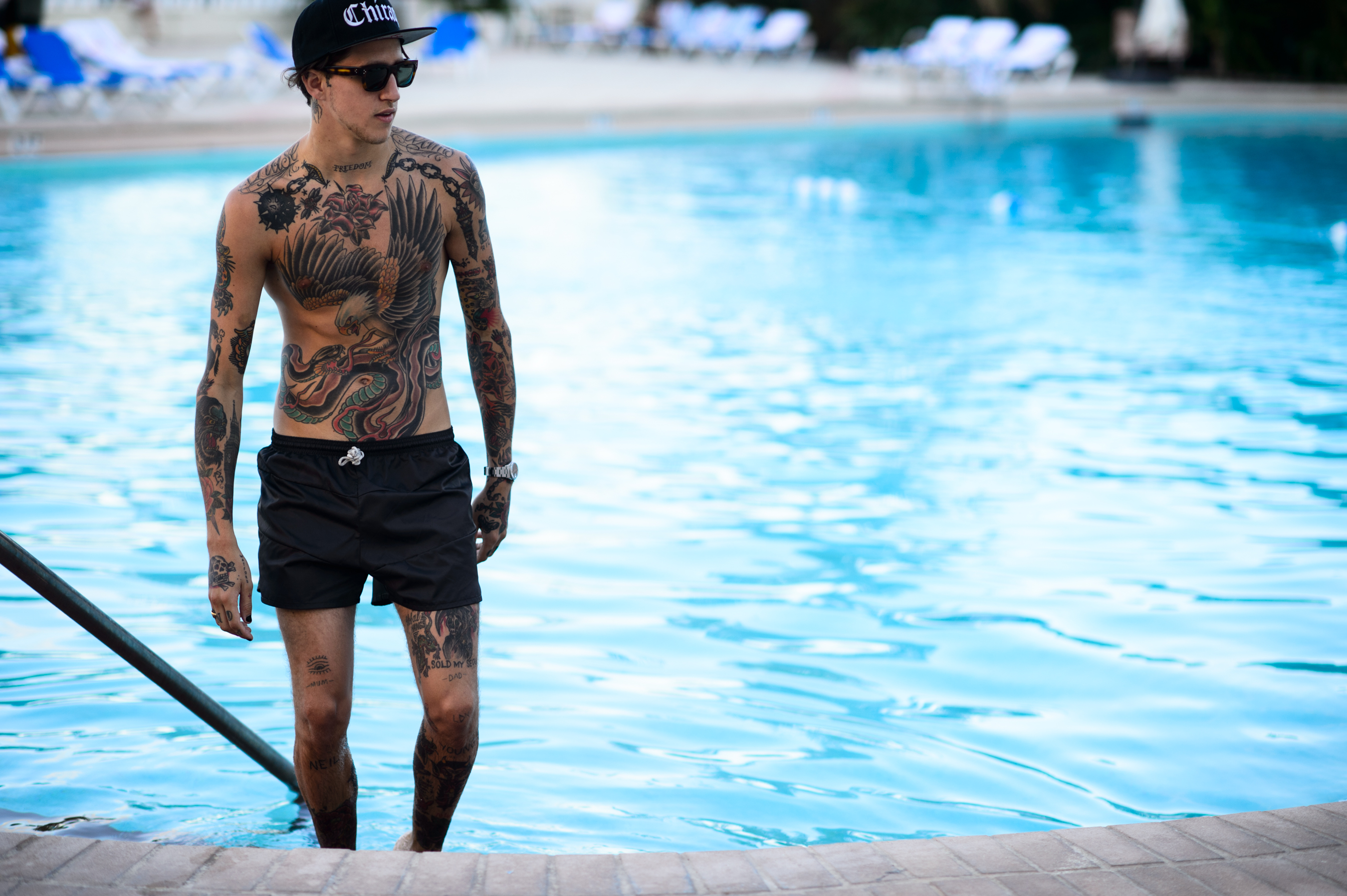 Male tattoo model in his swim trunks