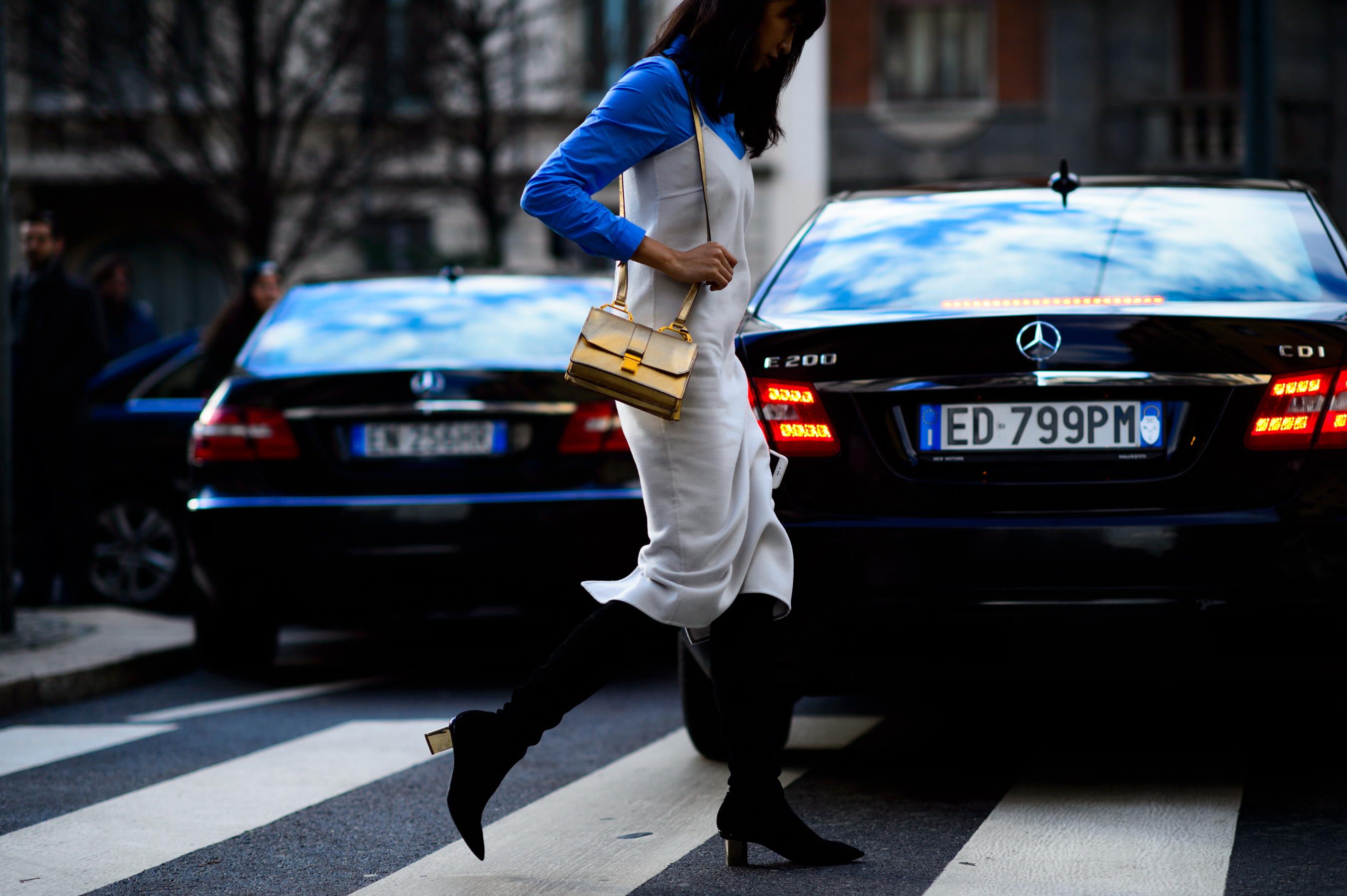 Woman wearing white jumpsuit and boots