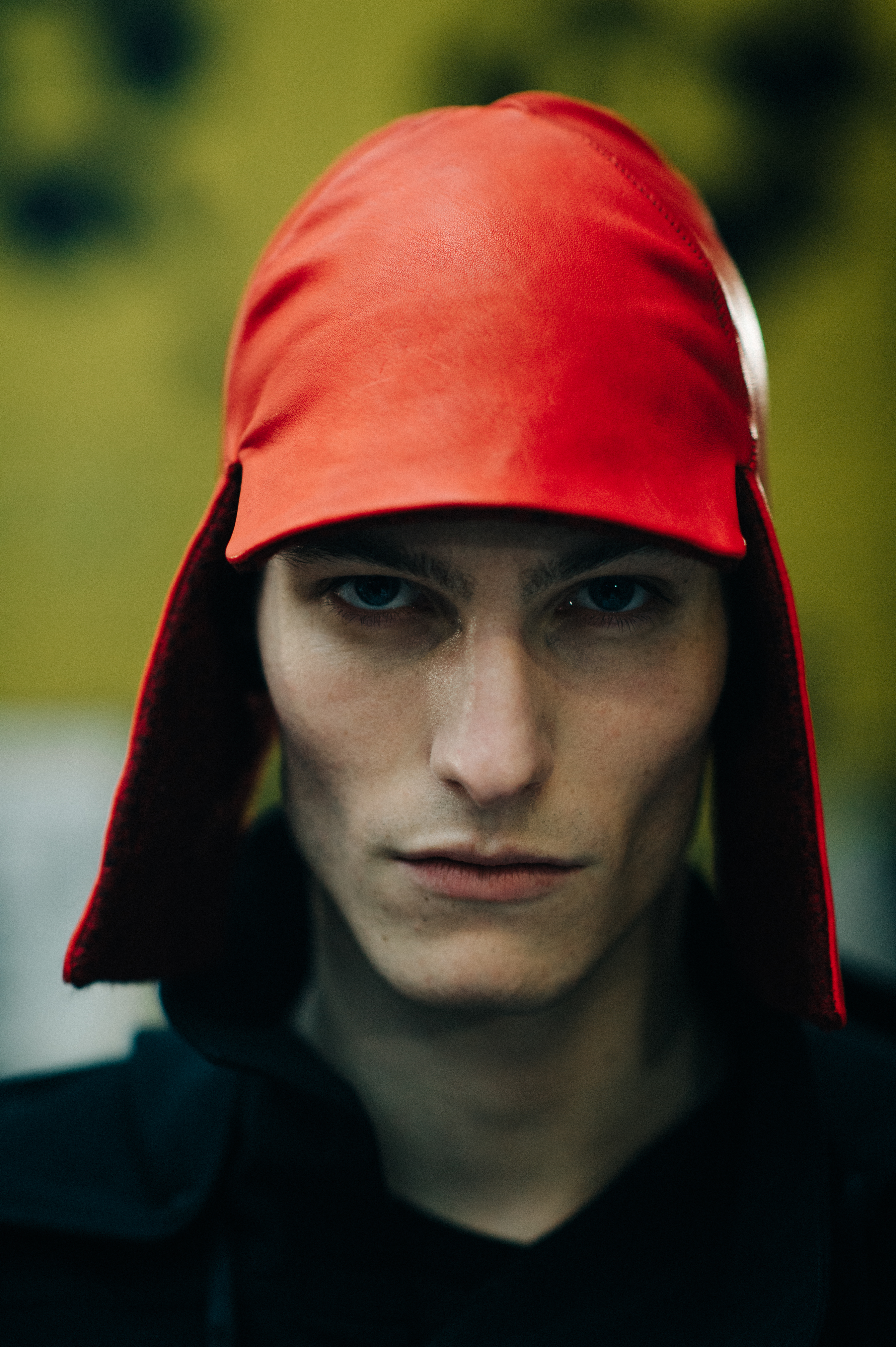 Male model wearing a red leather hat