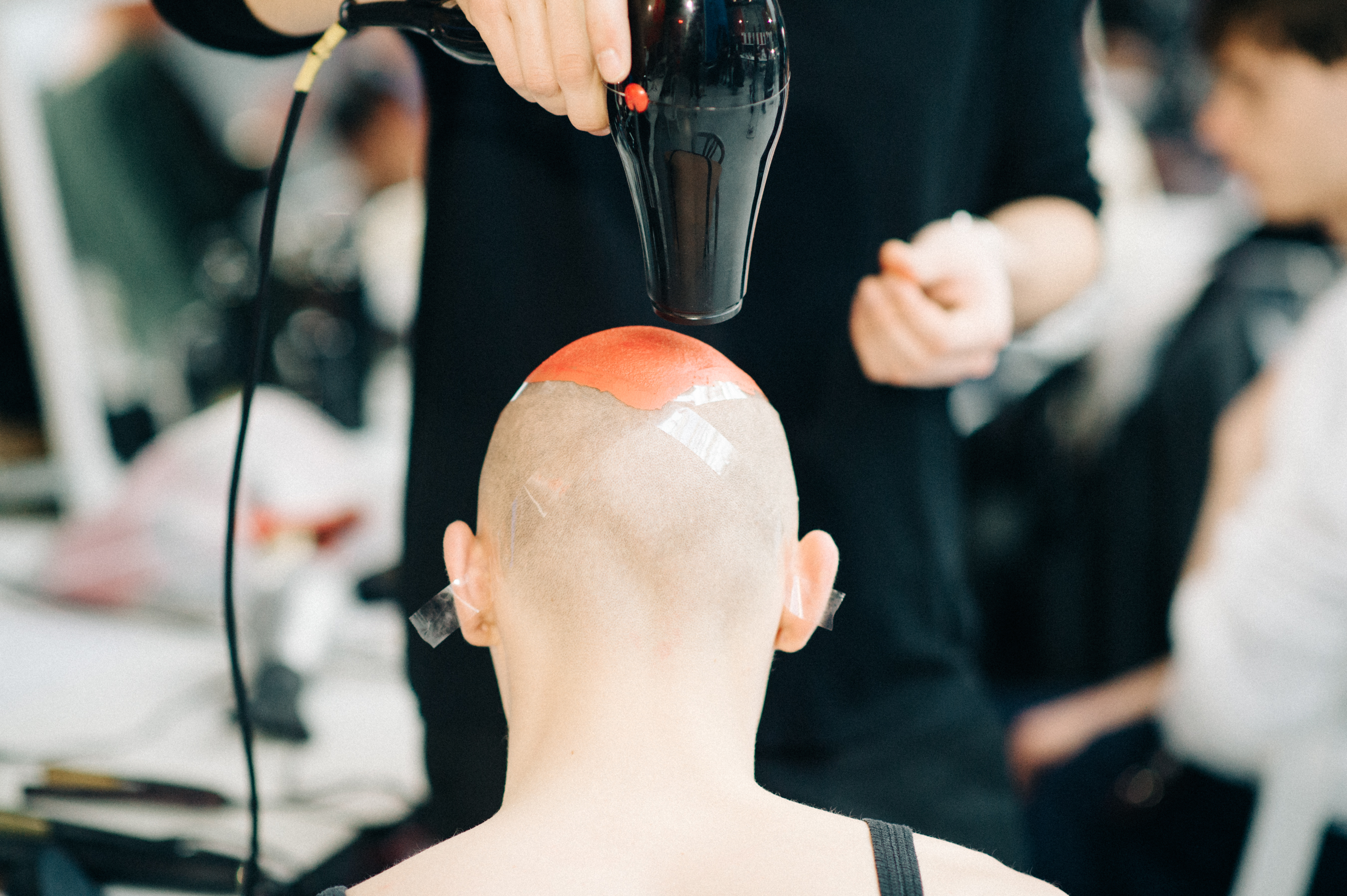 Male model getting his hair painted
