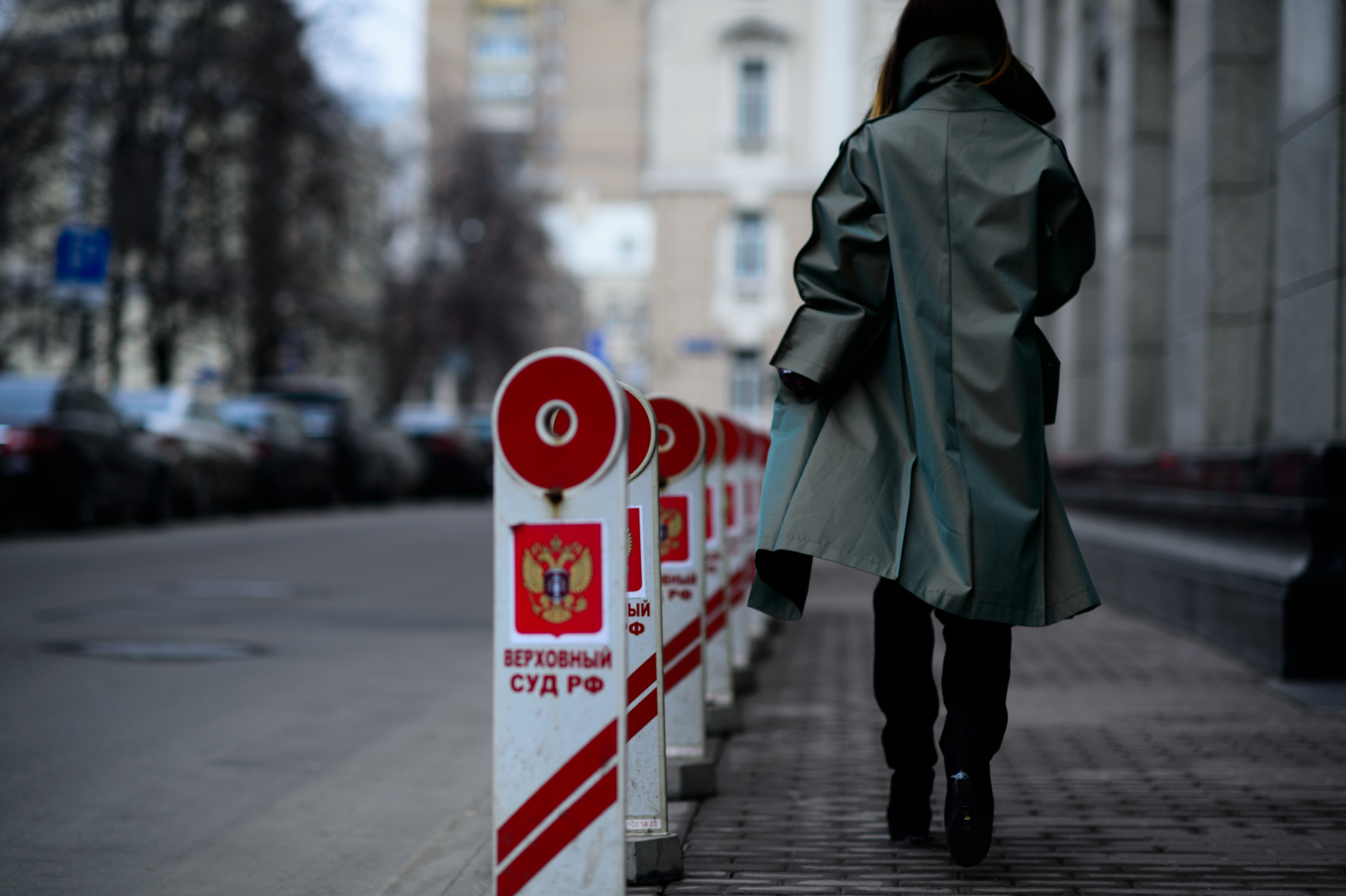 Russian woman wearing a green trenchcoat